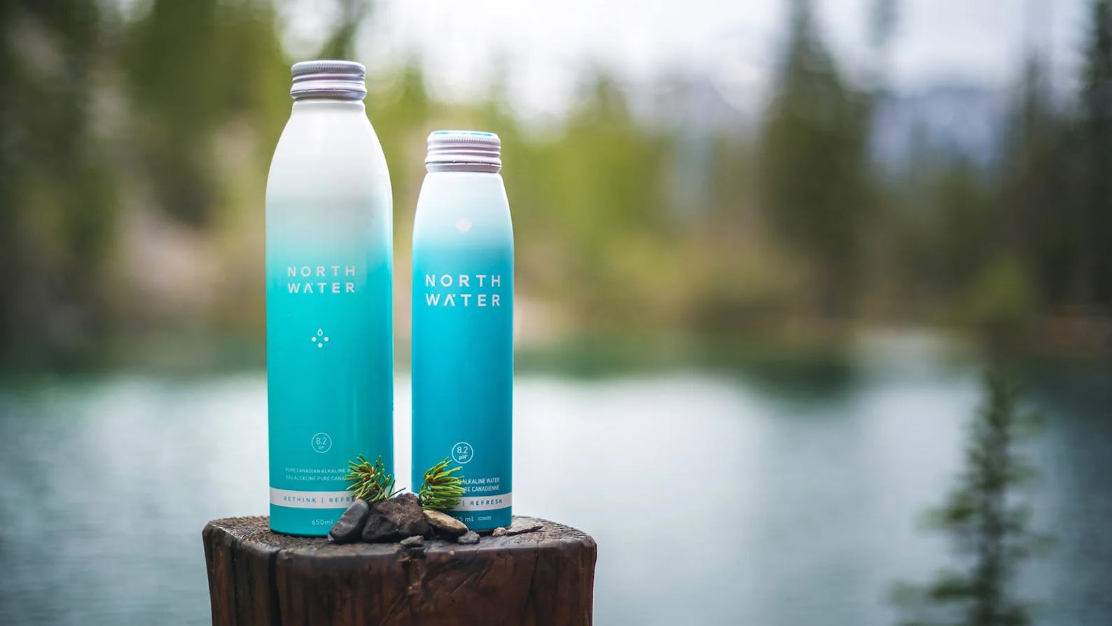 Canadian forest background with the North Water aluminum bottles in the foreground.