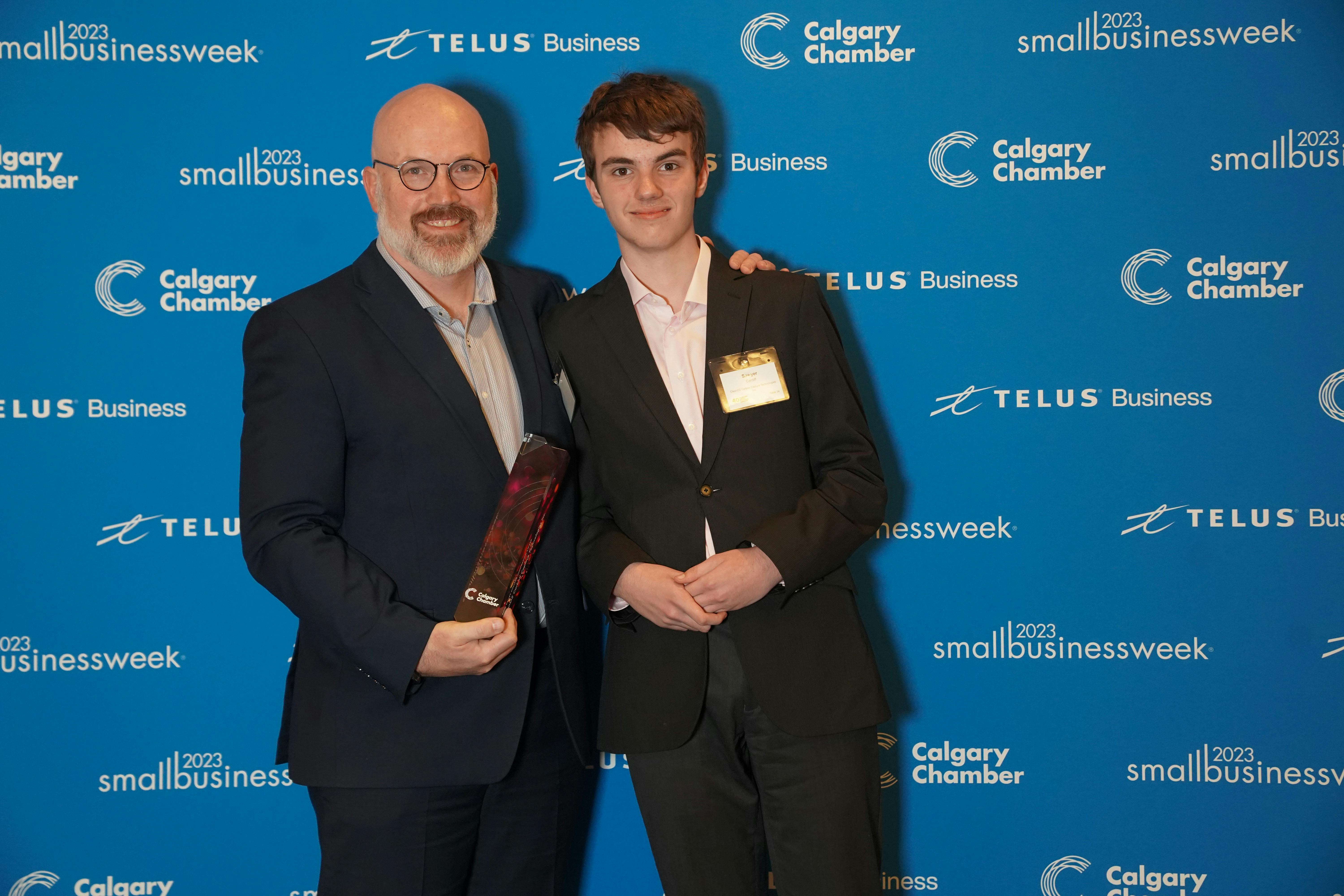 Jaeson Cardiff celebrates CleanO2's Calgary Small Business Award win with his son.