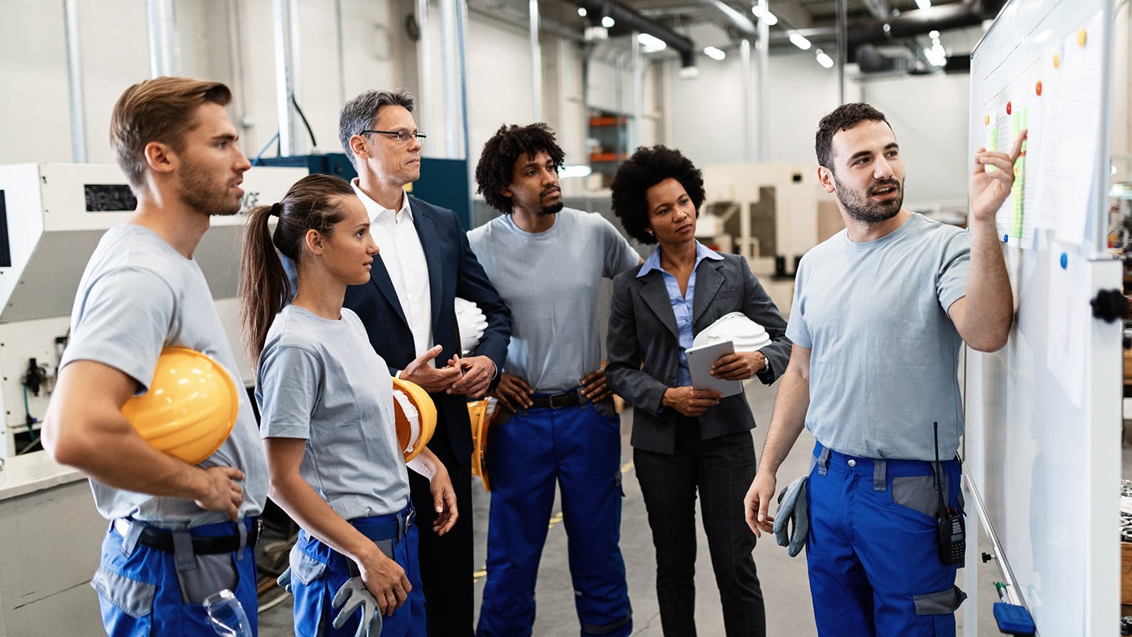 Co-workers gather to learn in an industrial setting