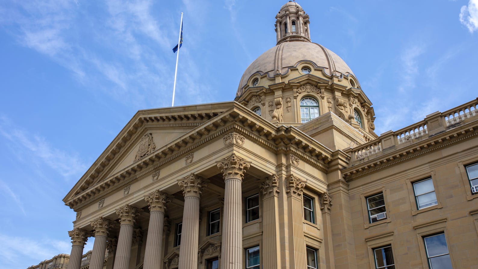 Alberta Legislature building from low perspective against blue sky