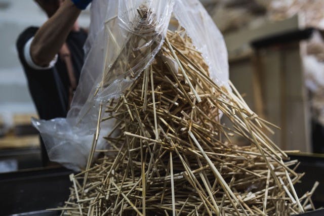 Chopsticks being dumped from a bag to be recycled