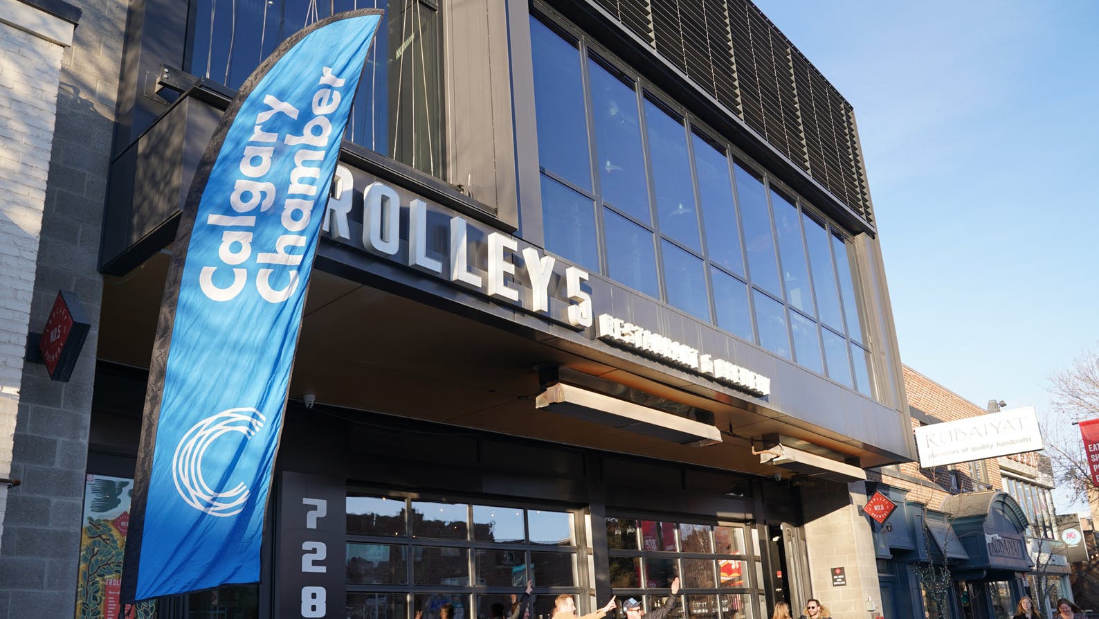 The Chamber flag waves outside Trolley 5, the venue for Confluence YYC: Money, presented by SureCall.