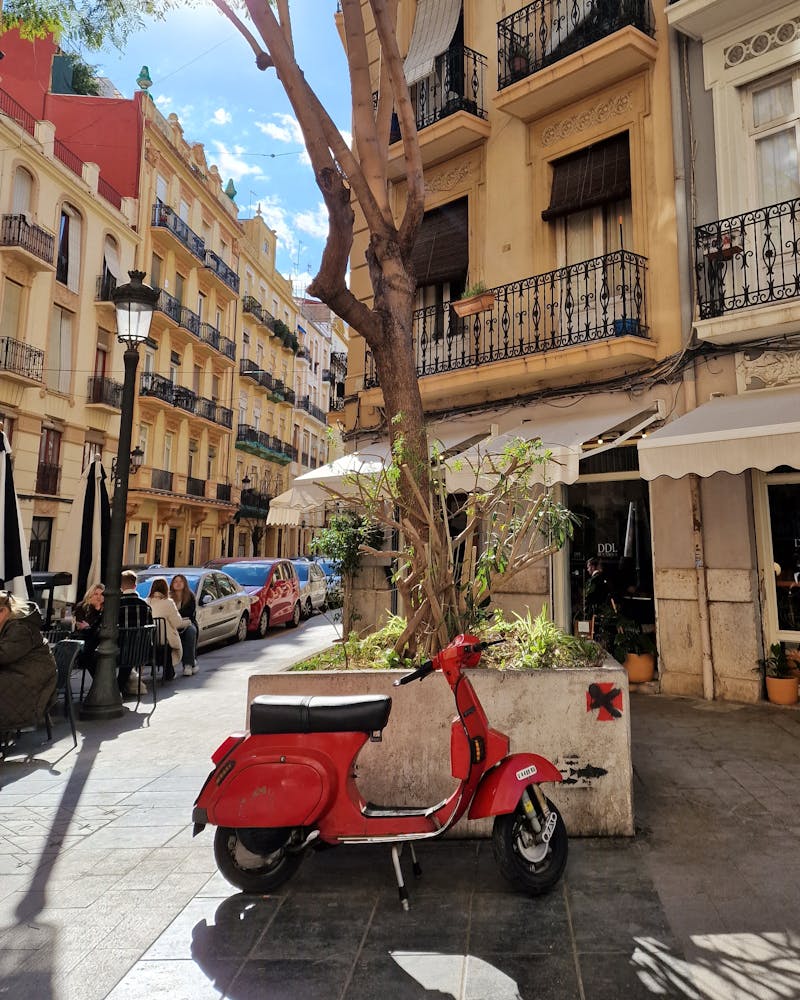 A Vespa parked in front of a typical coffee in the neighbourhood of Ruzafa, Valencia