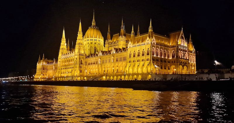 The Budapest Parliament seen at night from a boat on the Danube River, quite an experience in the city.