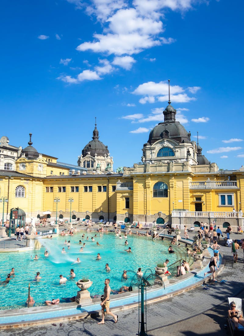 The most famous thermal baths in Budapest with people relaxing, one of the things to do at any time of year