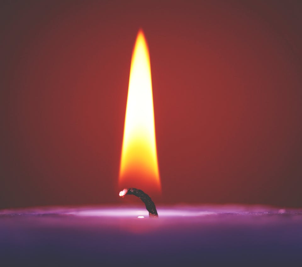 closeup of flame on purple candle