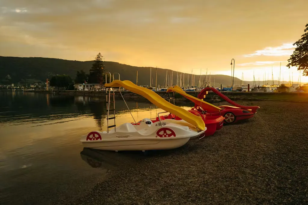 Pedalos am Seeufer bei Sonnenuntergang