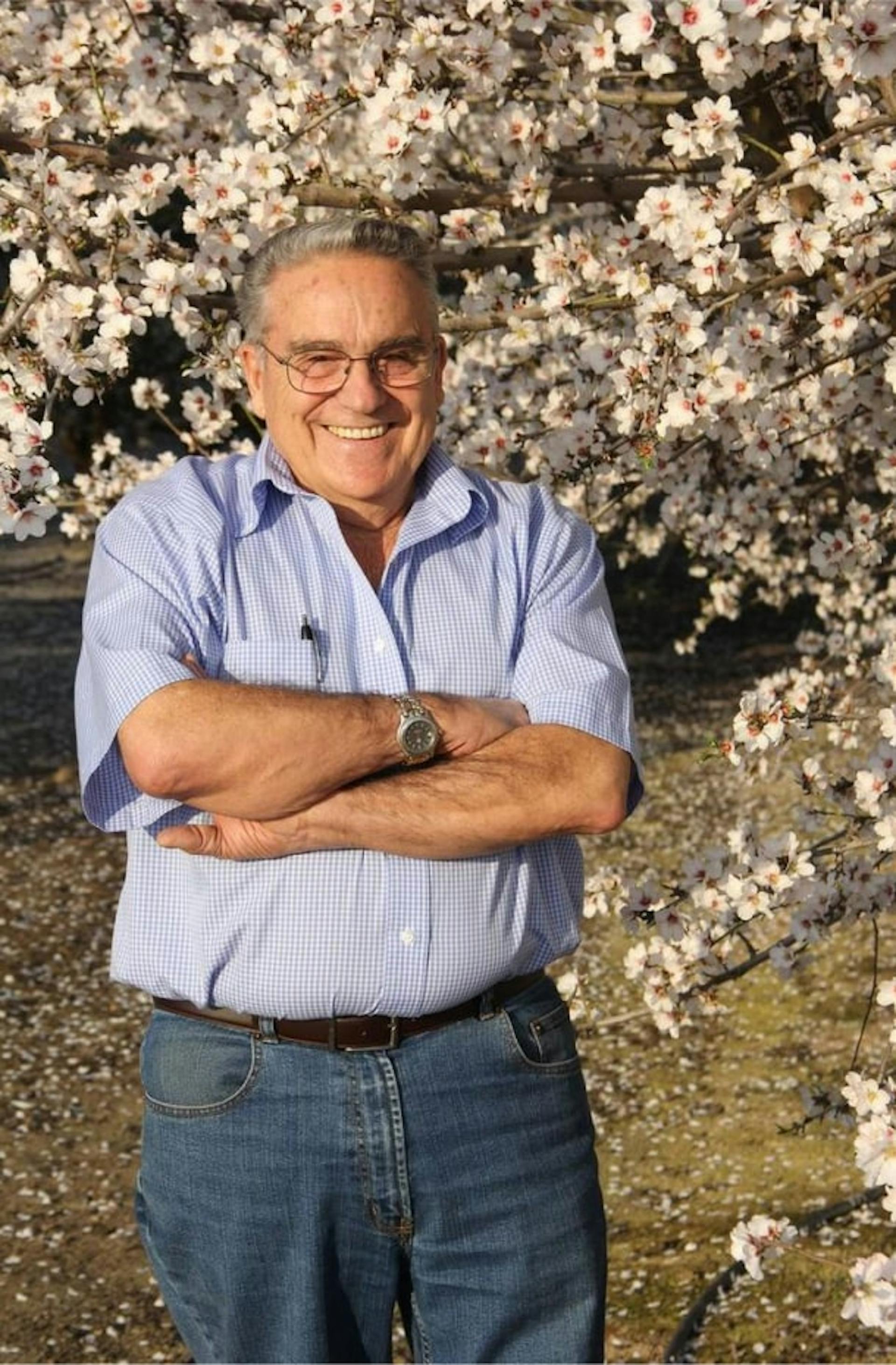 Tony Campos standing in beautiful almond orchard
