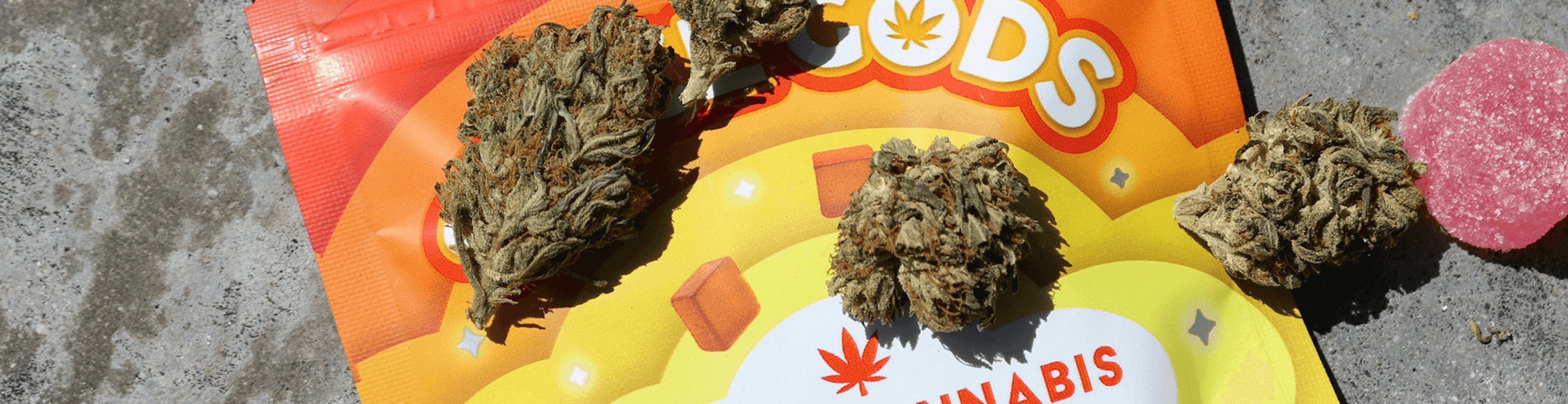 Legal cannabis buds and infused edibles on colorful packaging labeled 'Legal Cannabis Gummies