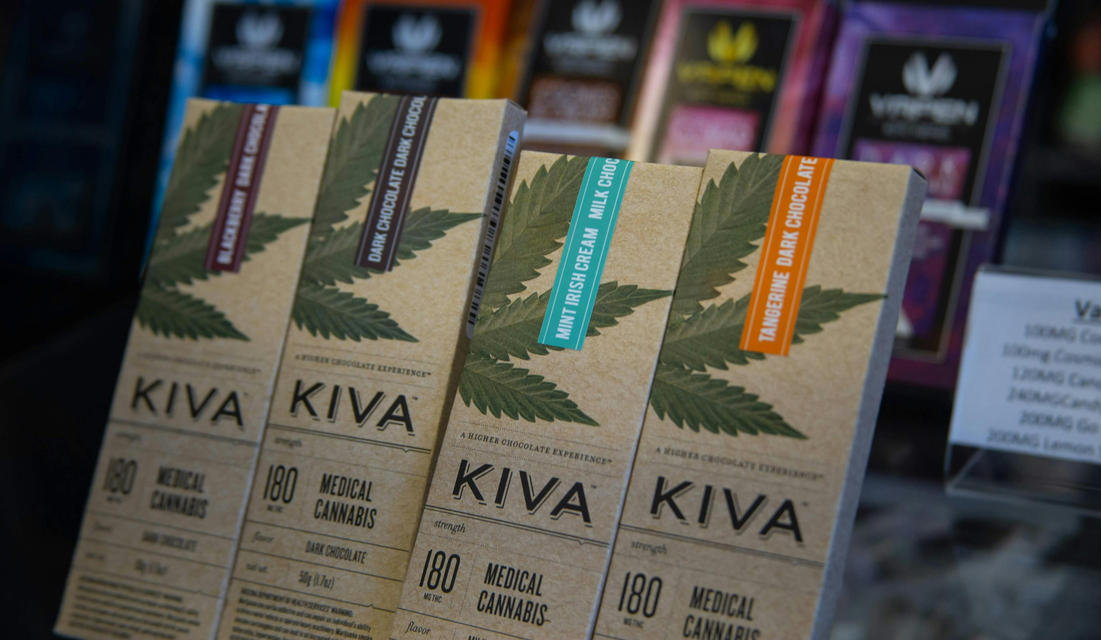 Display of Kiva medical cannabis chocolate bars in various flavors, each labeled with 180mg THC content