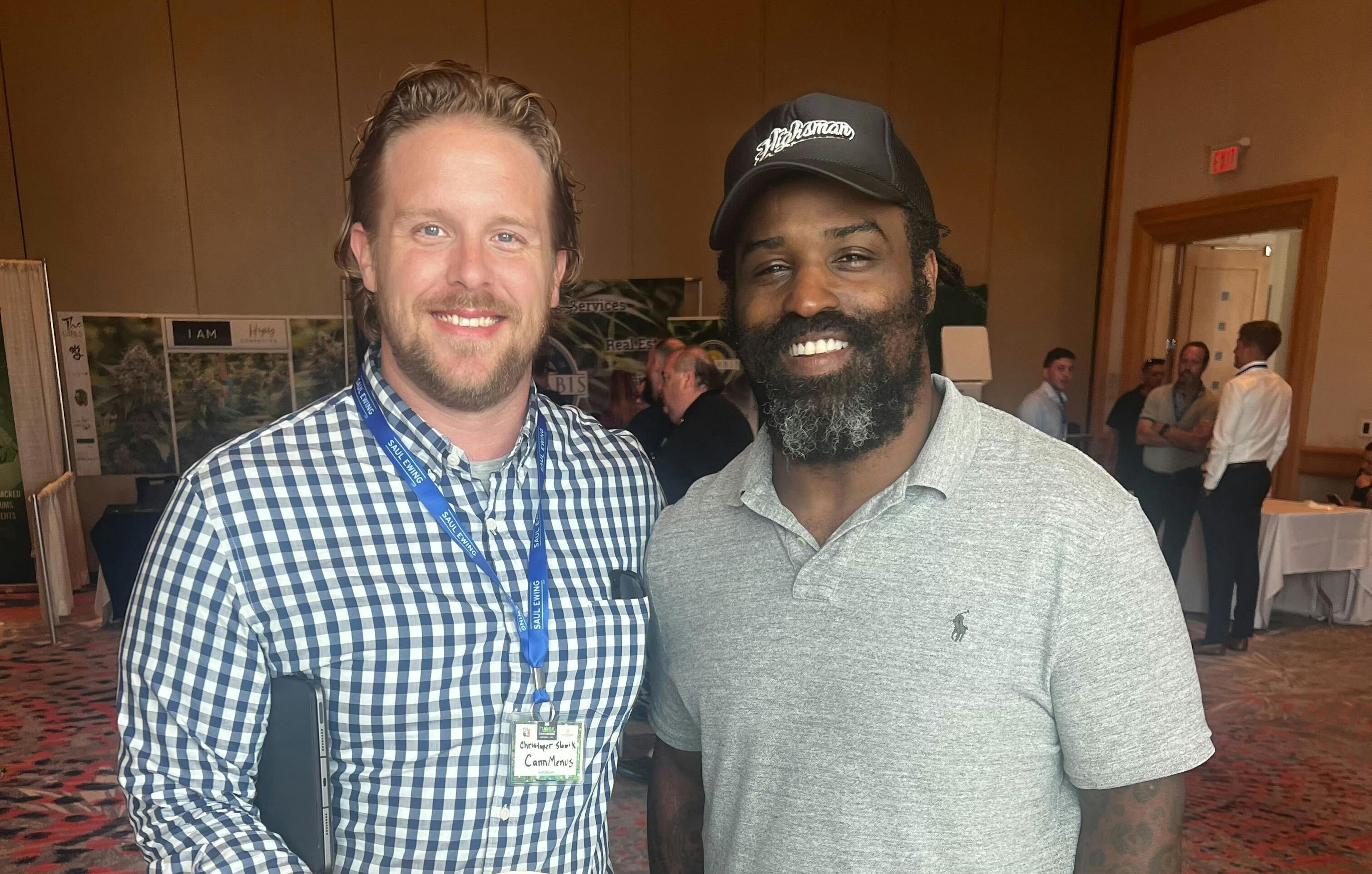 Two smiling individuals at a cannabis conference in Florida