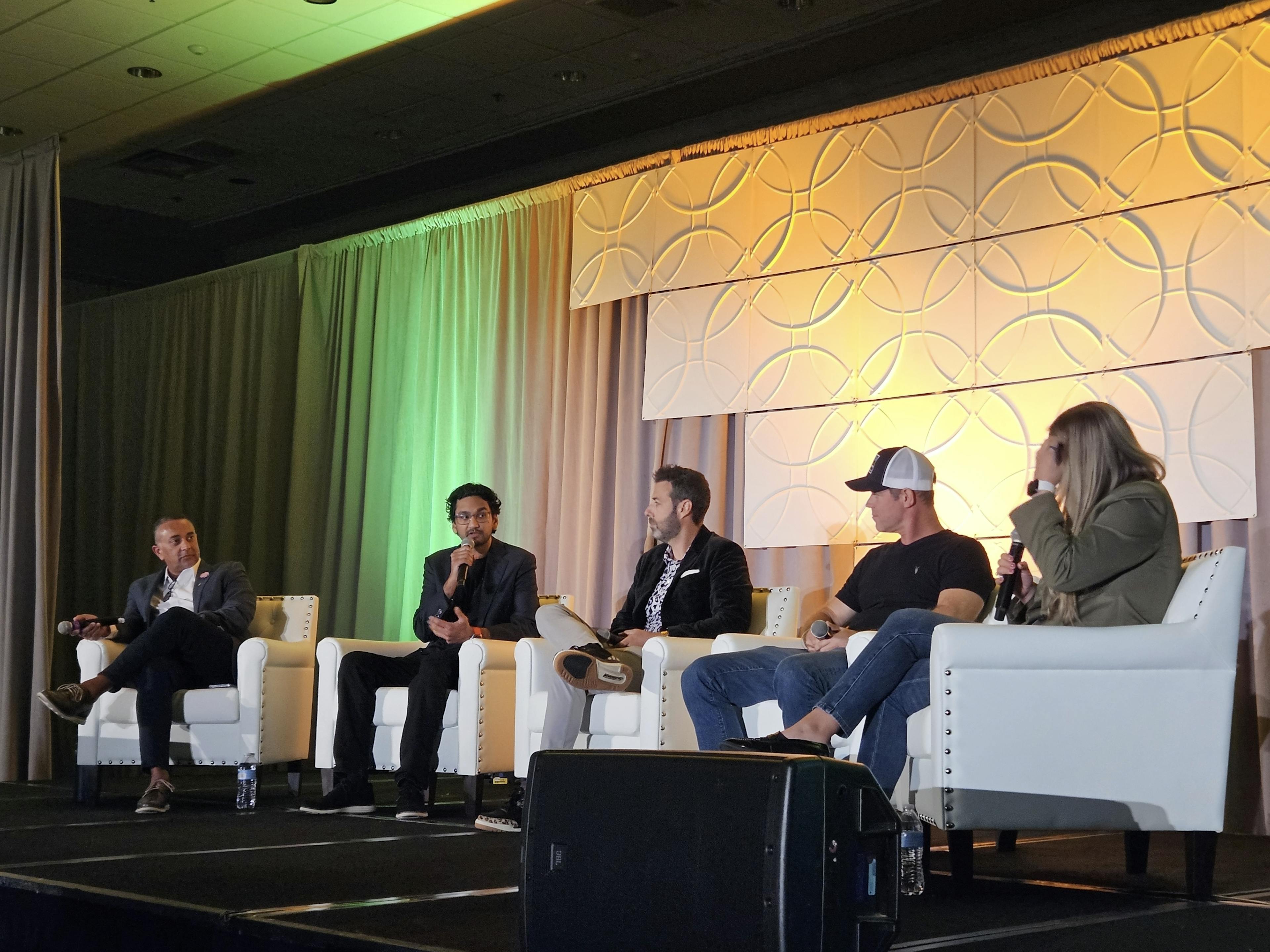 Cannabis professionals speaking on a panel at the Benzinga Cannabis Conference in Chicago.