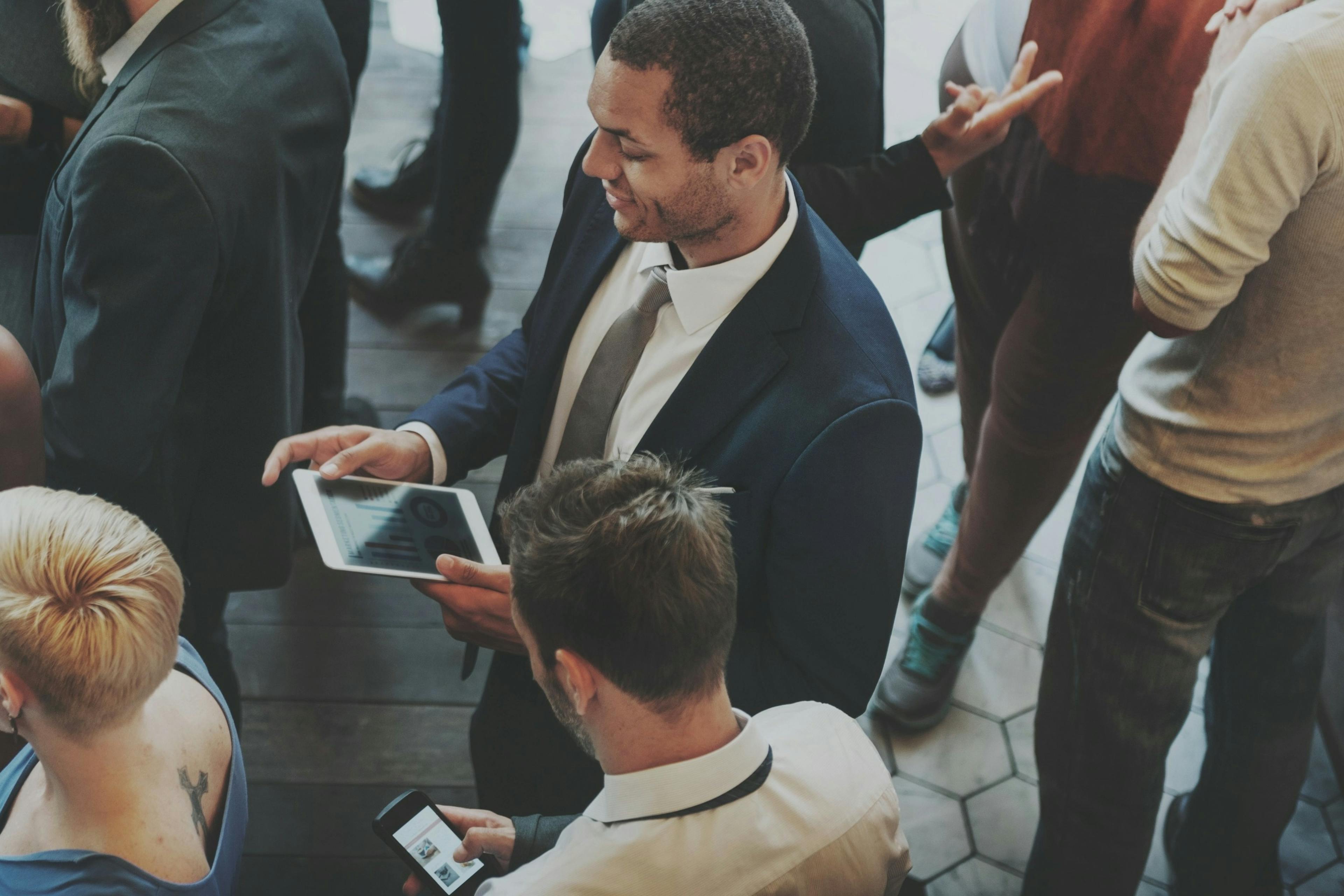 People in suits standing around.