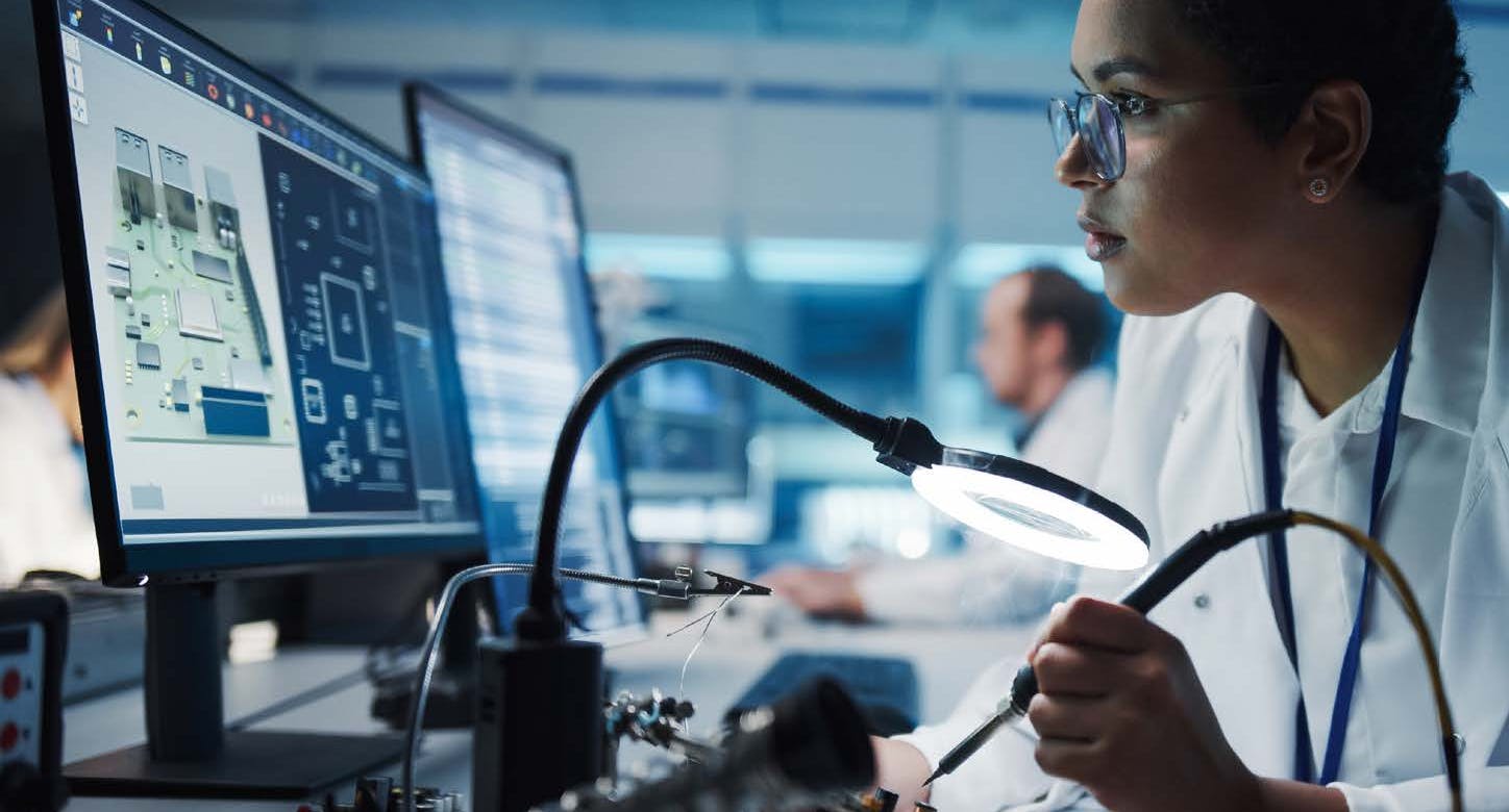 Someone working on a circuit board.