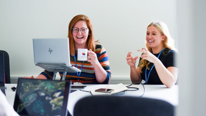 Two Canny Comms team members working.