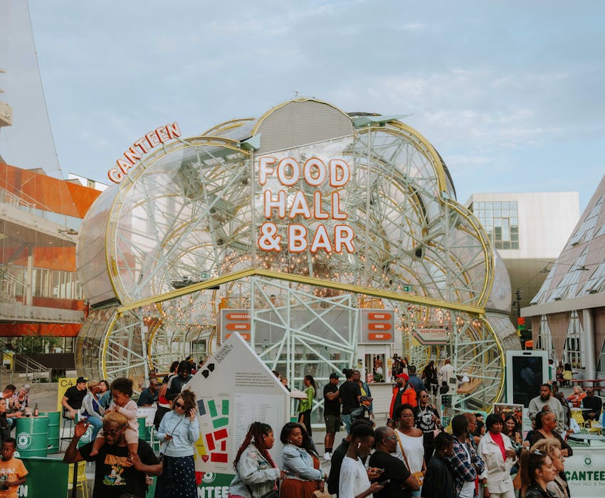 image of canteen food hall with groups of people having drink outside