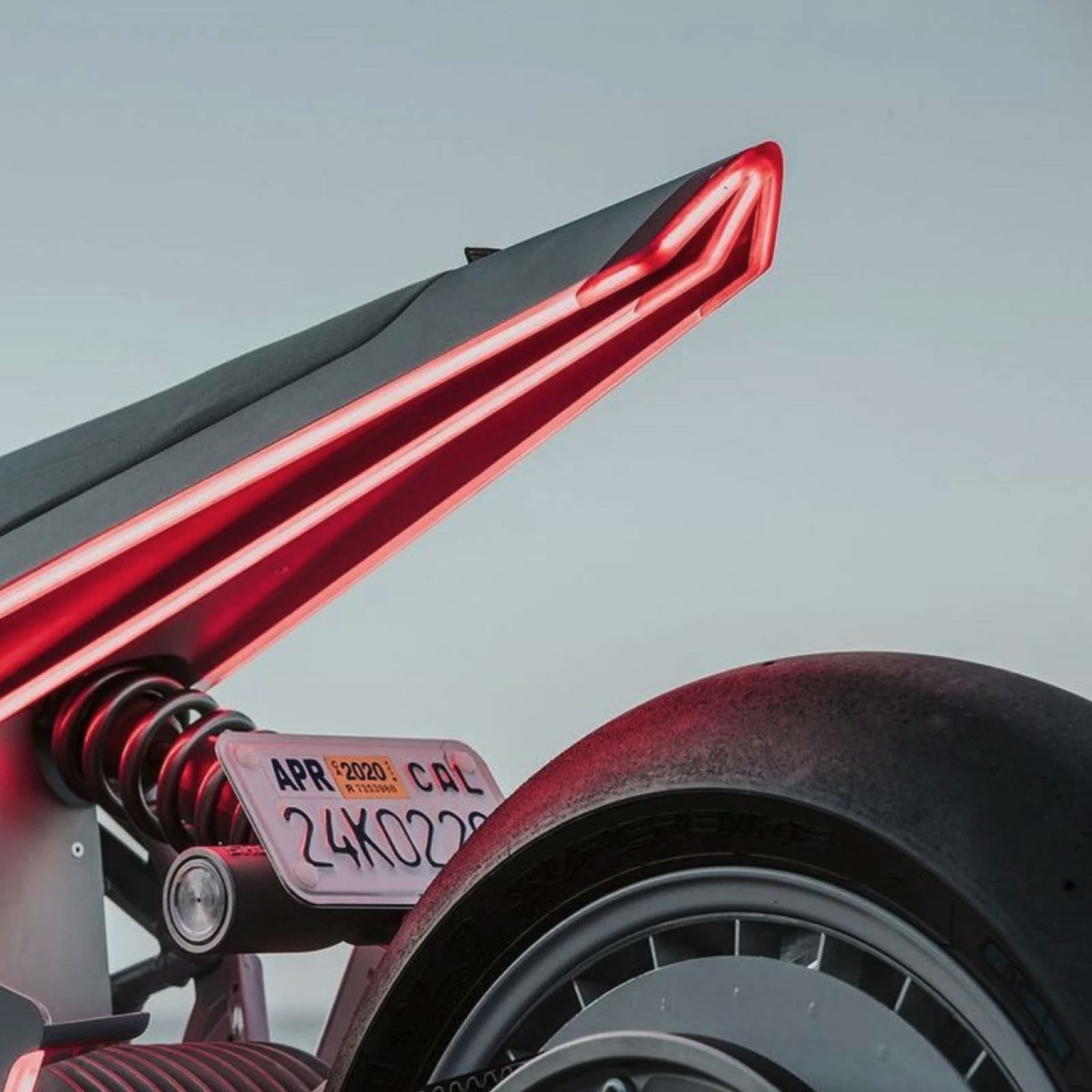 Back view of motorcycle with red lights.