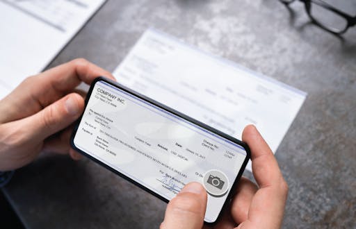 Person using their phone to deposit a check into their bank account.