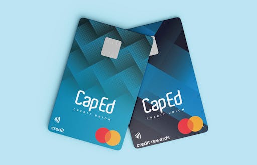 Two blue credit cards with CapEd logo and Mastercard logo.
