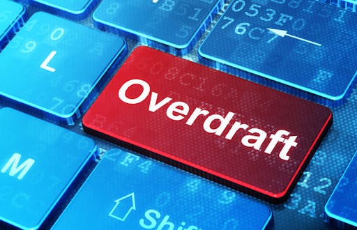 Blue computer keyboard with a red Enter key that says Overdraft instead of Enter.