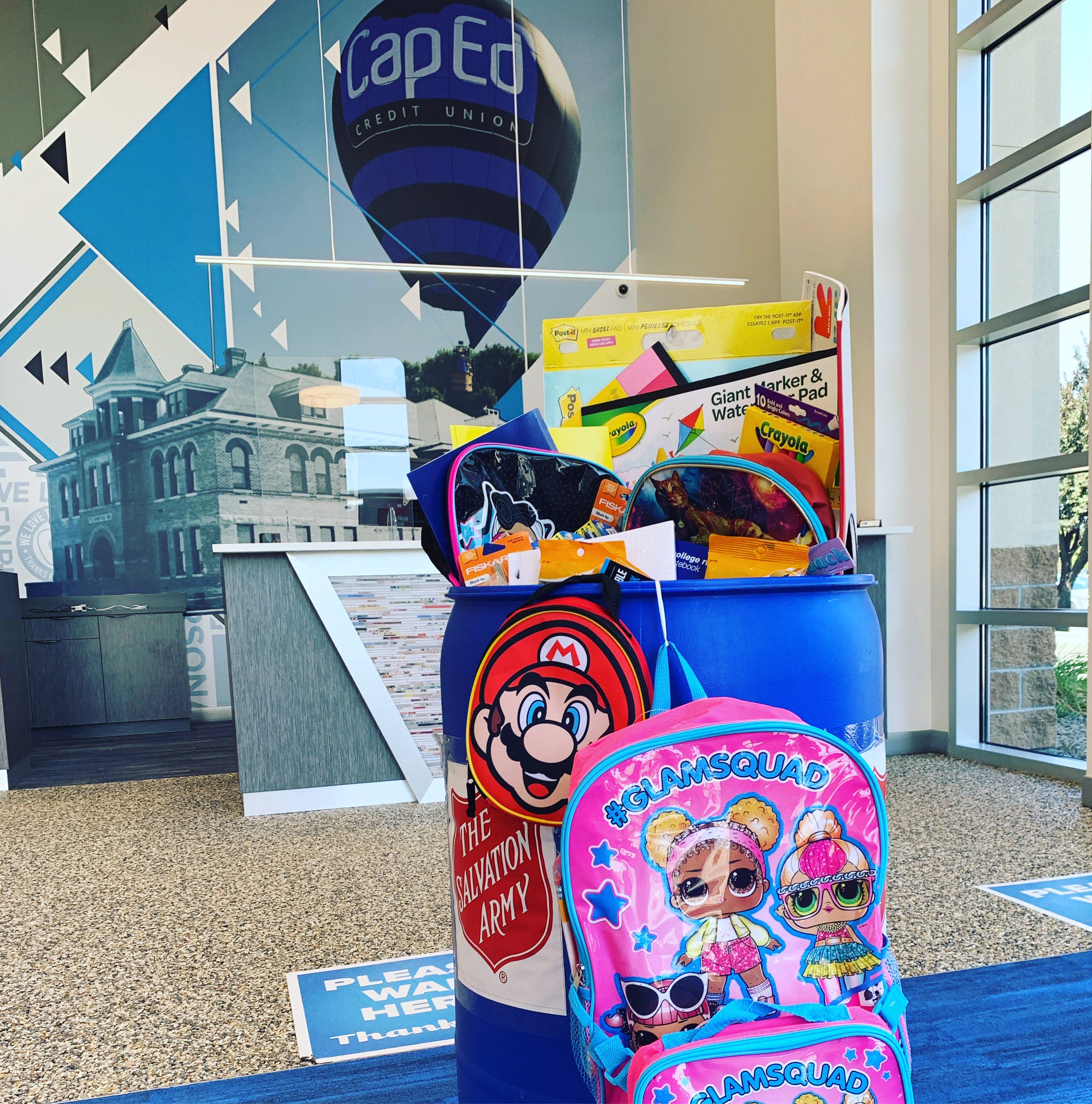 Donation bin for the Back to School drive filled with school supplies.