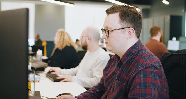 Employees working at their desk