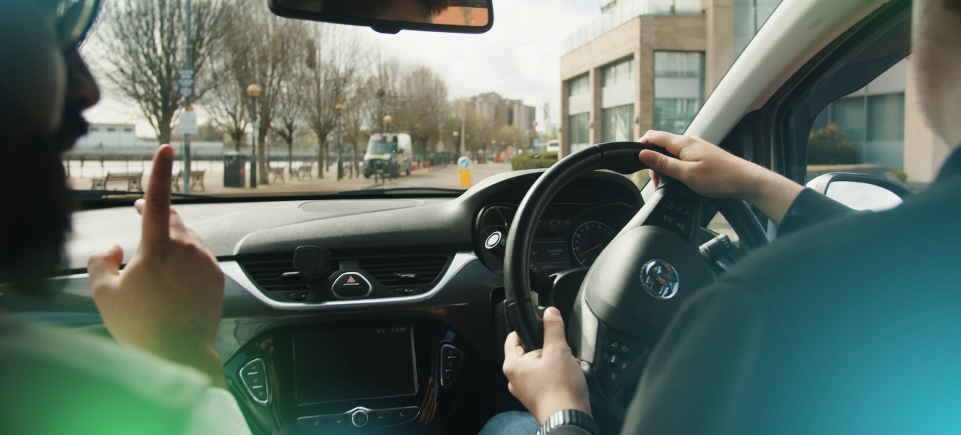 An instructor teaching a learner how to drive