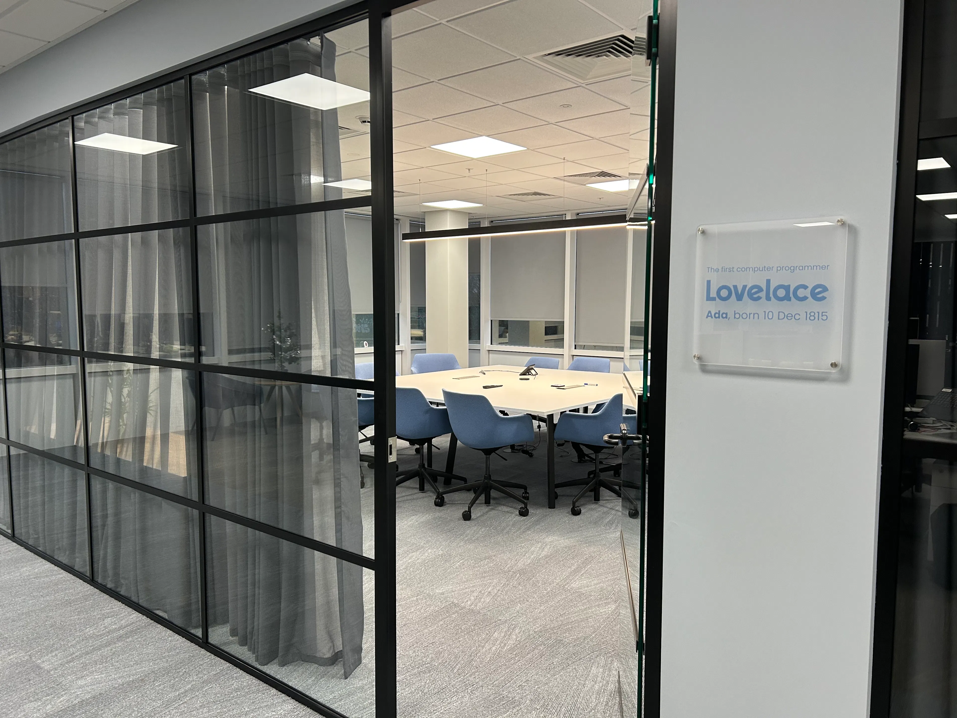 An image of a meeting room with a sign including the name of the room, "Lovelace"
