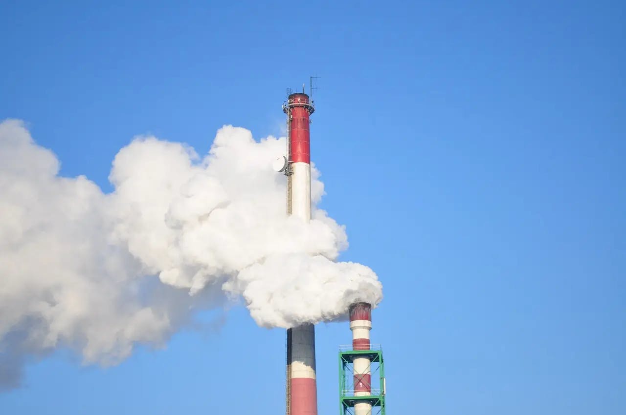 Image of a chimney emitting greenhouse gases.