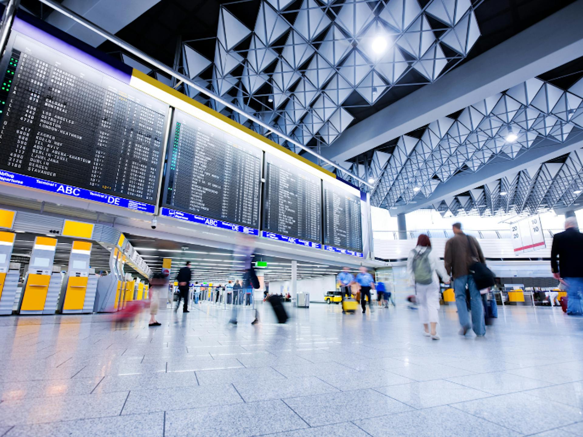 Airport passengers walking through a terminal