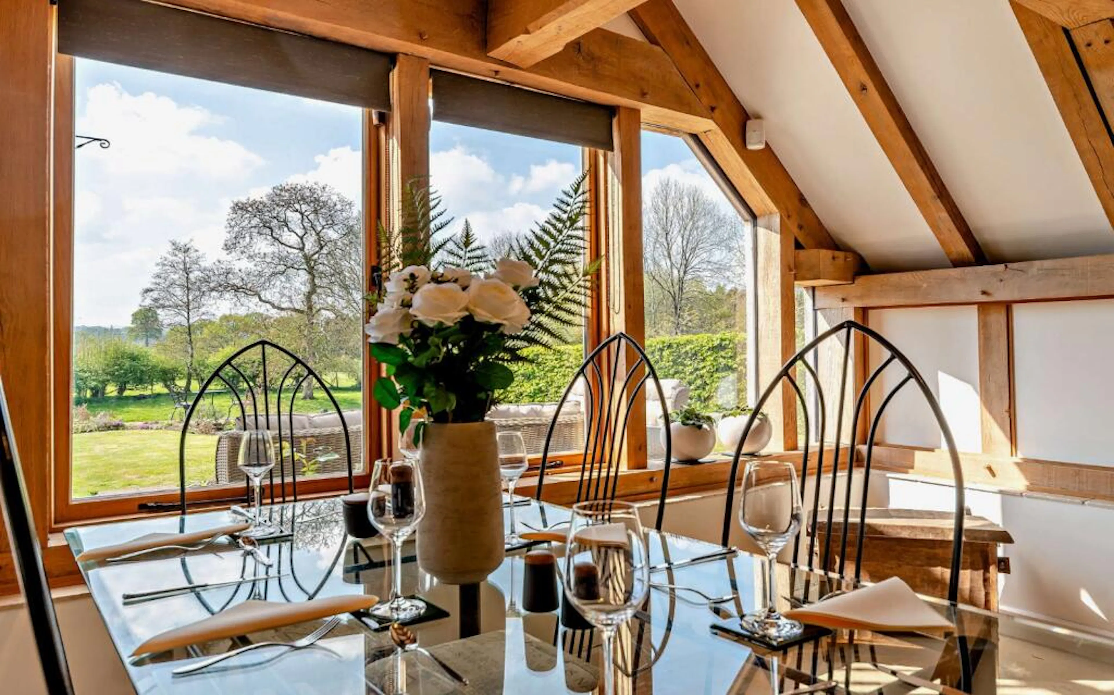 A dining area with views of a garden in an oak framed extension