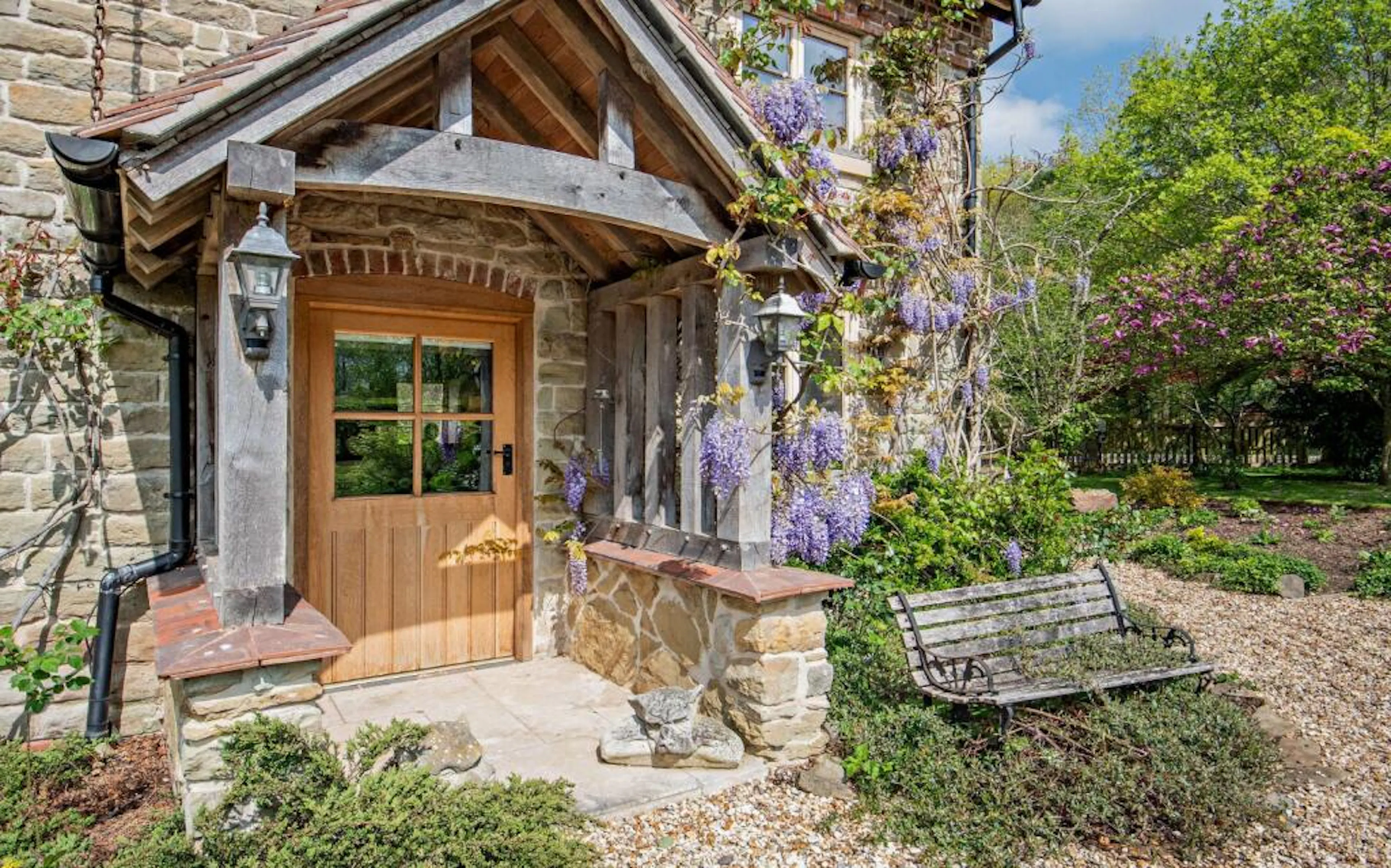 An oak framed porch on a traditional stone cottage