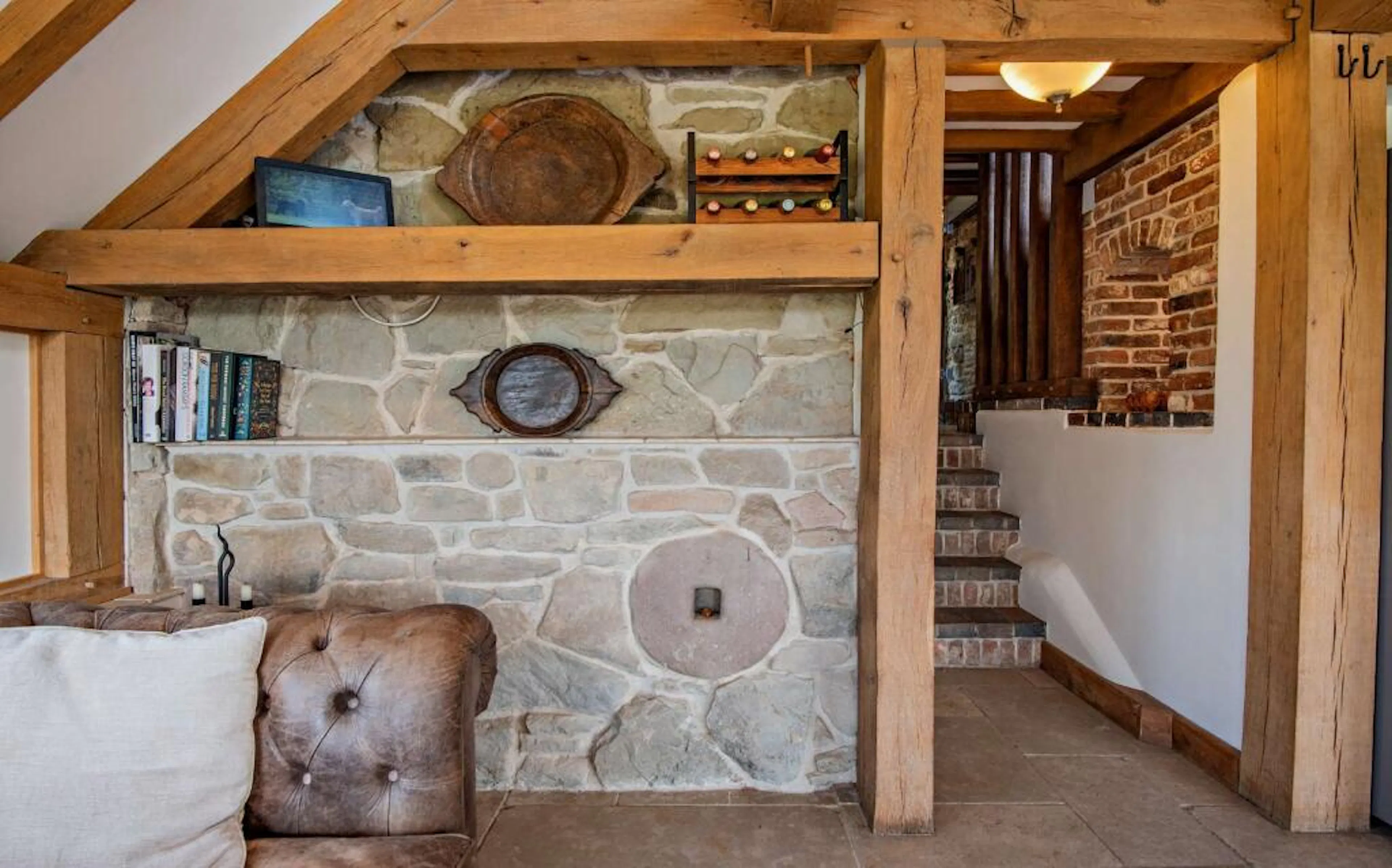 A sitting area and corner bookshelf in an oak framed extension