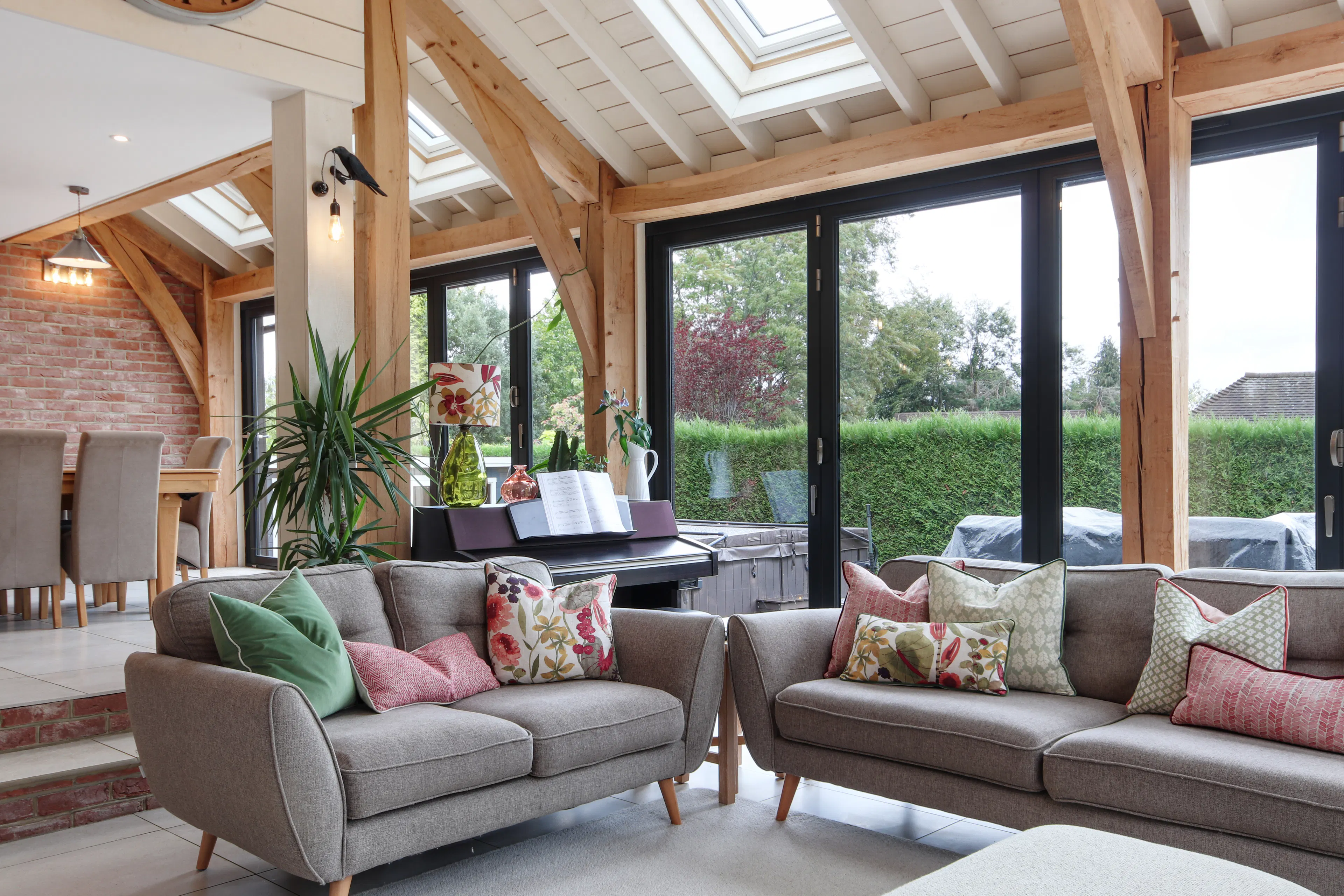 A modern oak framed extension encompassing an open plan family room and dining area with integrated glazing and roof lights providing lots of natural light.