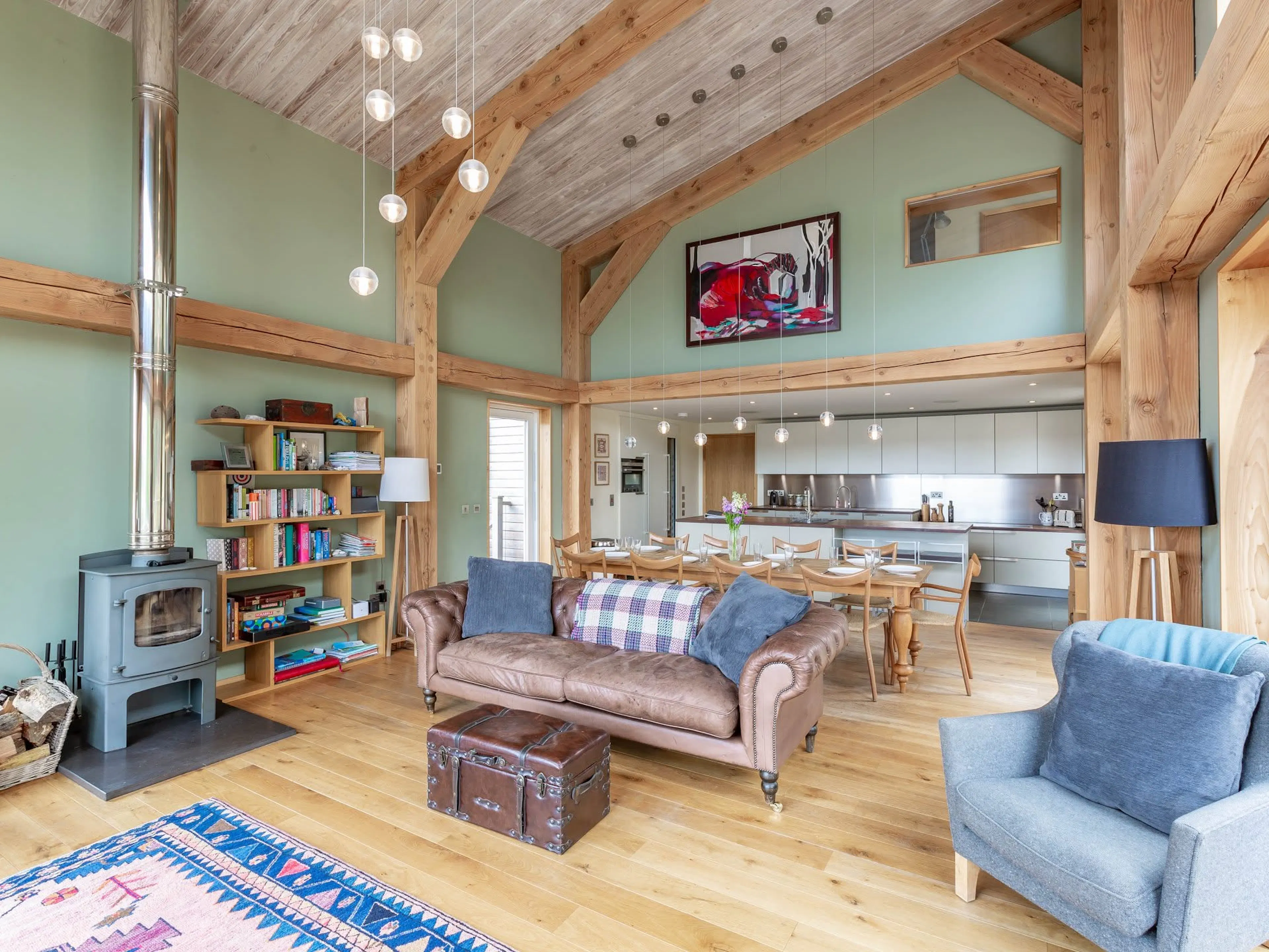 Interior view of a Douglas fir framed house with an open plan living room, dining area and kitchen