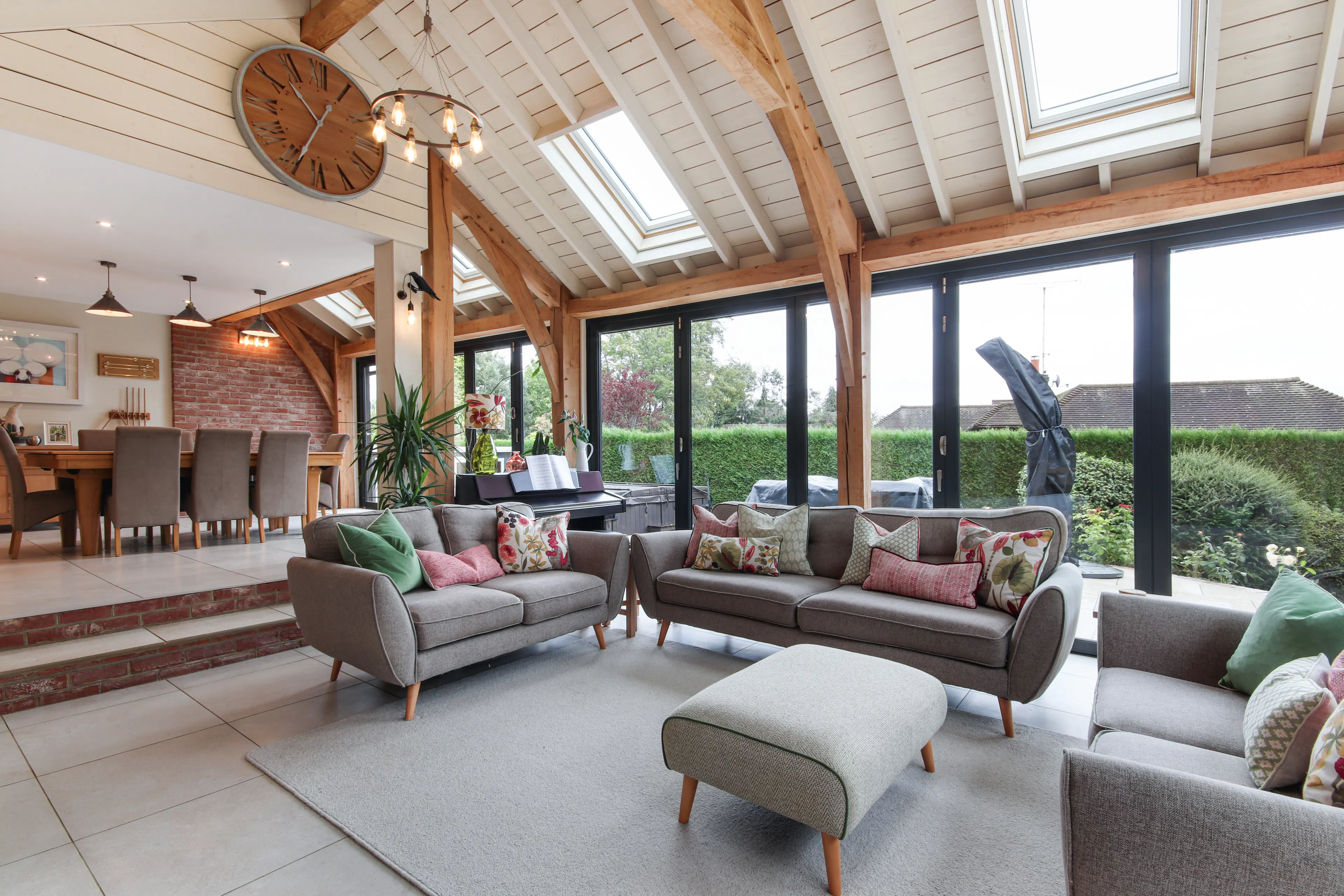 A modern oak framed extension encompassing an open plan family room and dining area with integrated glazing and roof lights providing lots of natural light.