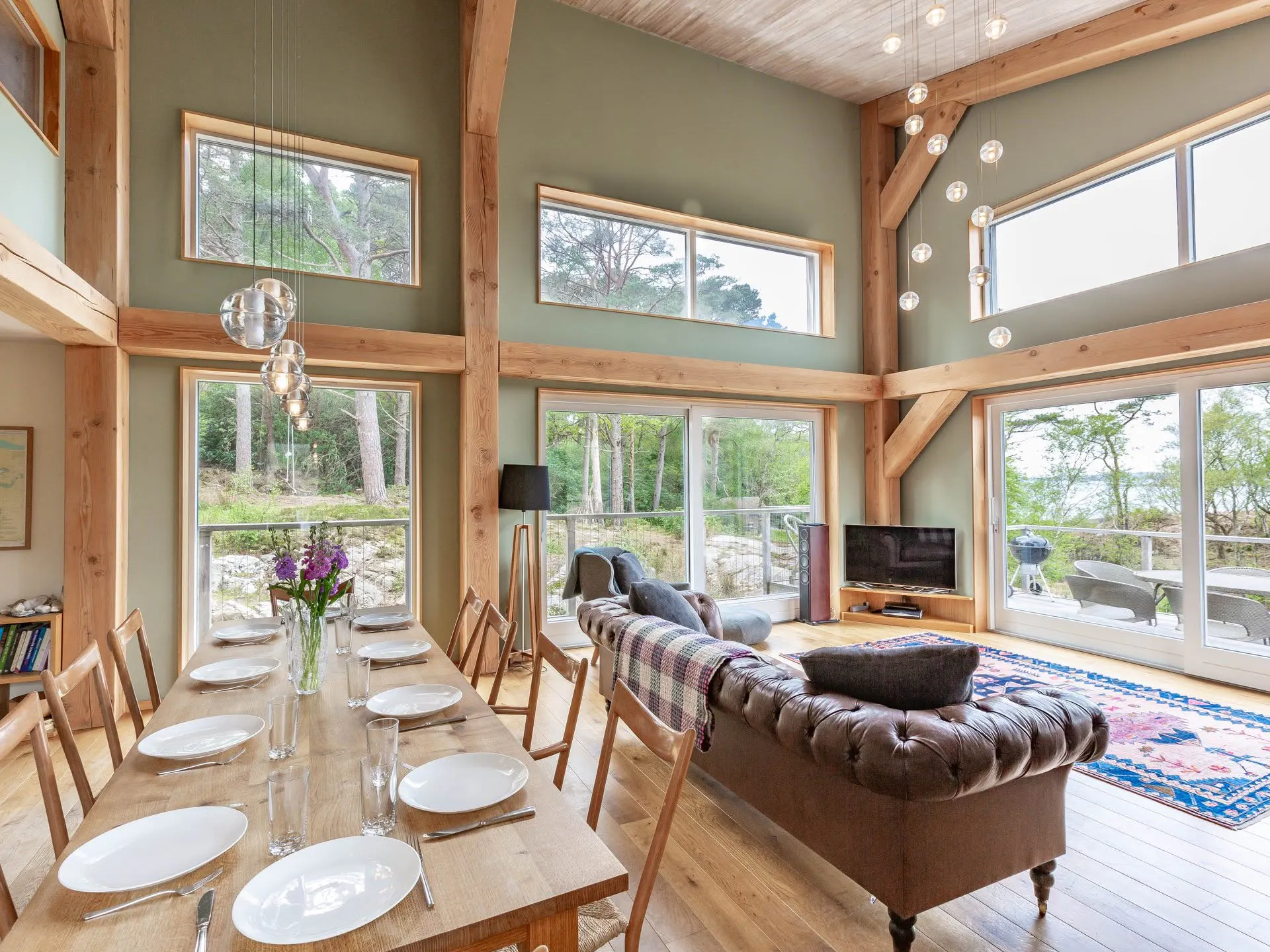 Interior view of a Douglas fir framed house with an open plan living room and dining area