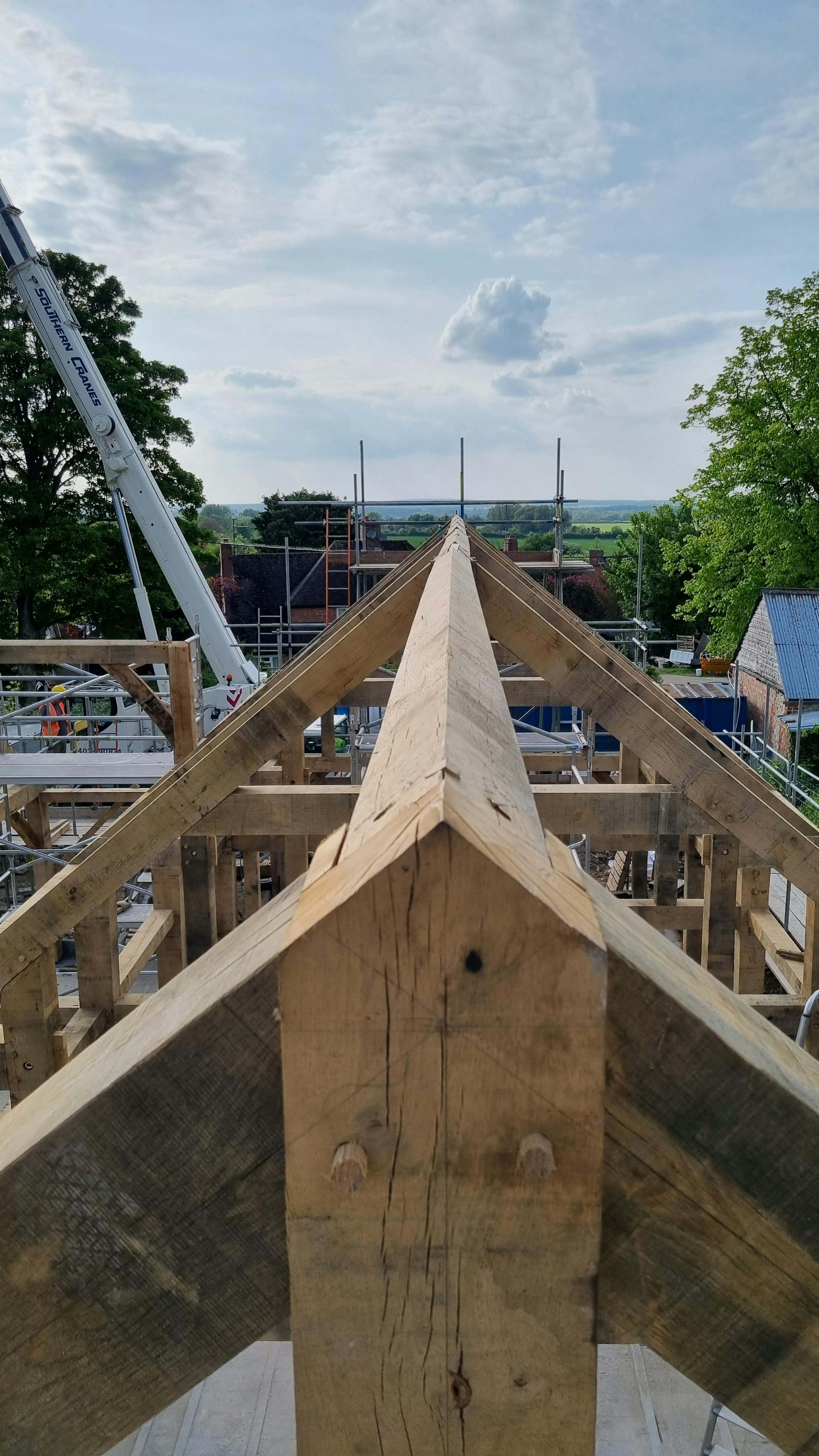 The view along the top of an oak frame home during installation