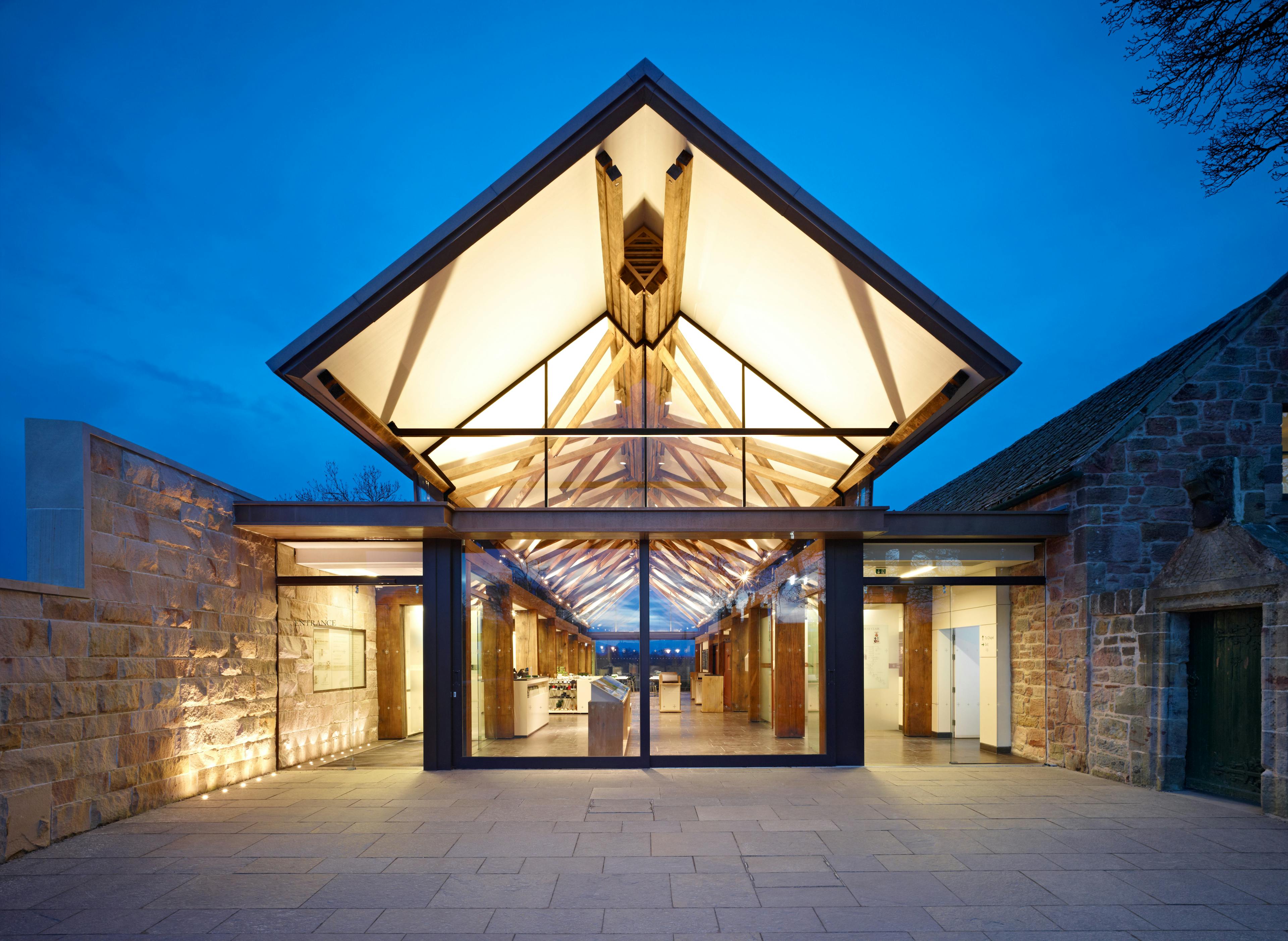 Exterior view of Rosslyn Chapel visitors centre, showcasing the internal structural timber frame through the windows
