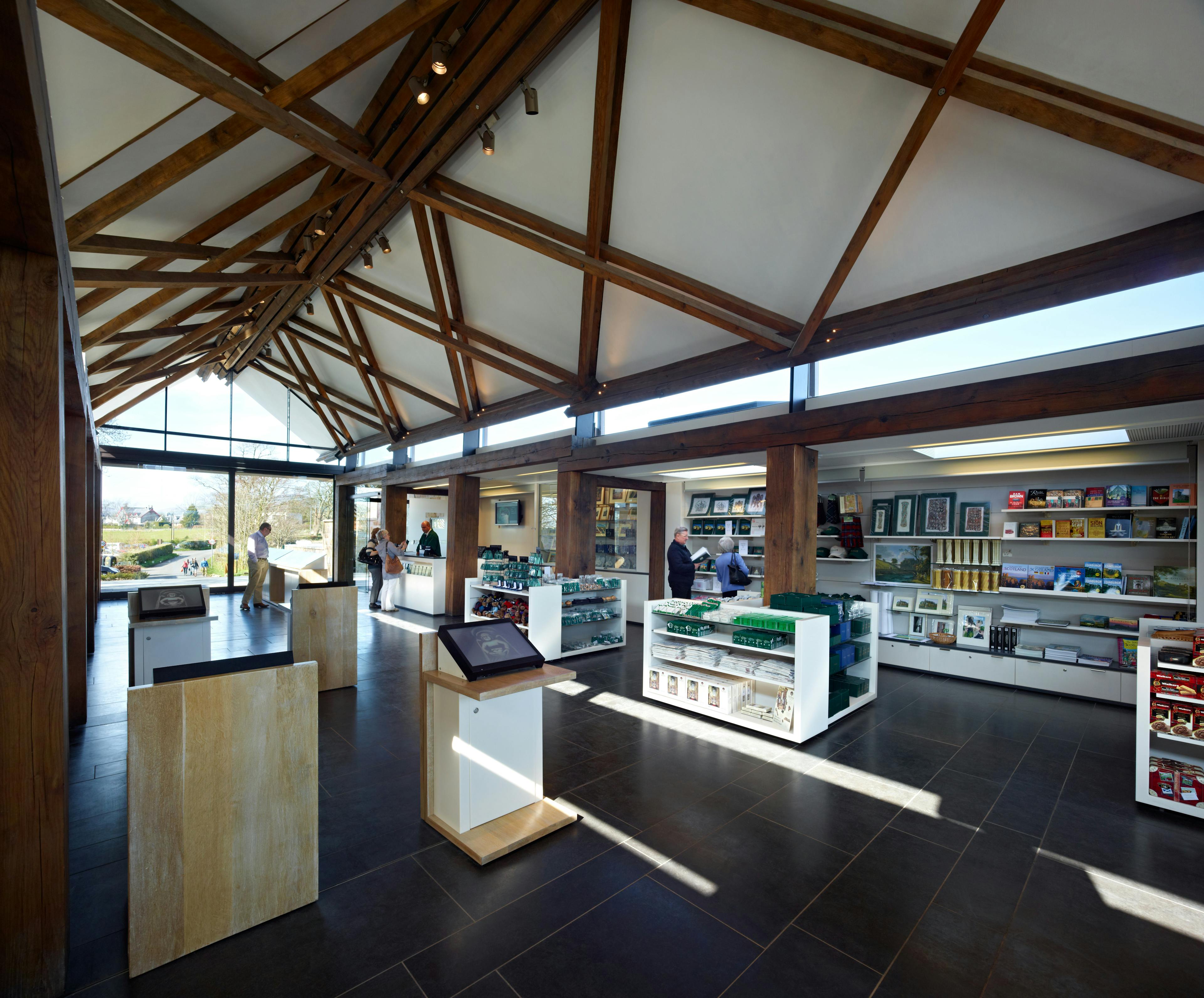 A visitors centre at a chapel in Scotland with scissor braced slender timbers create a criss-crossed timber framed roof structure