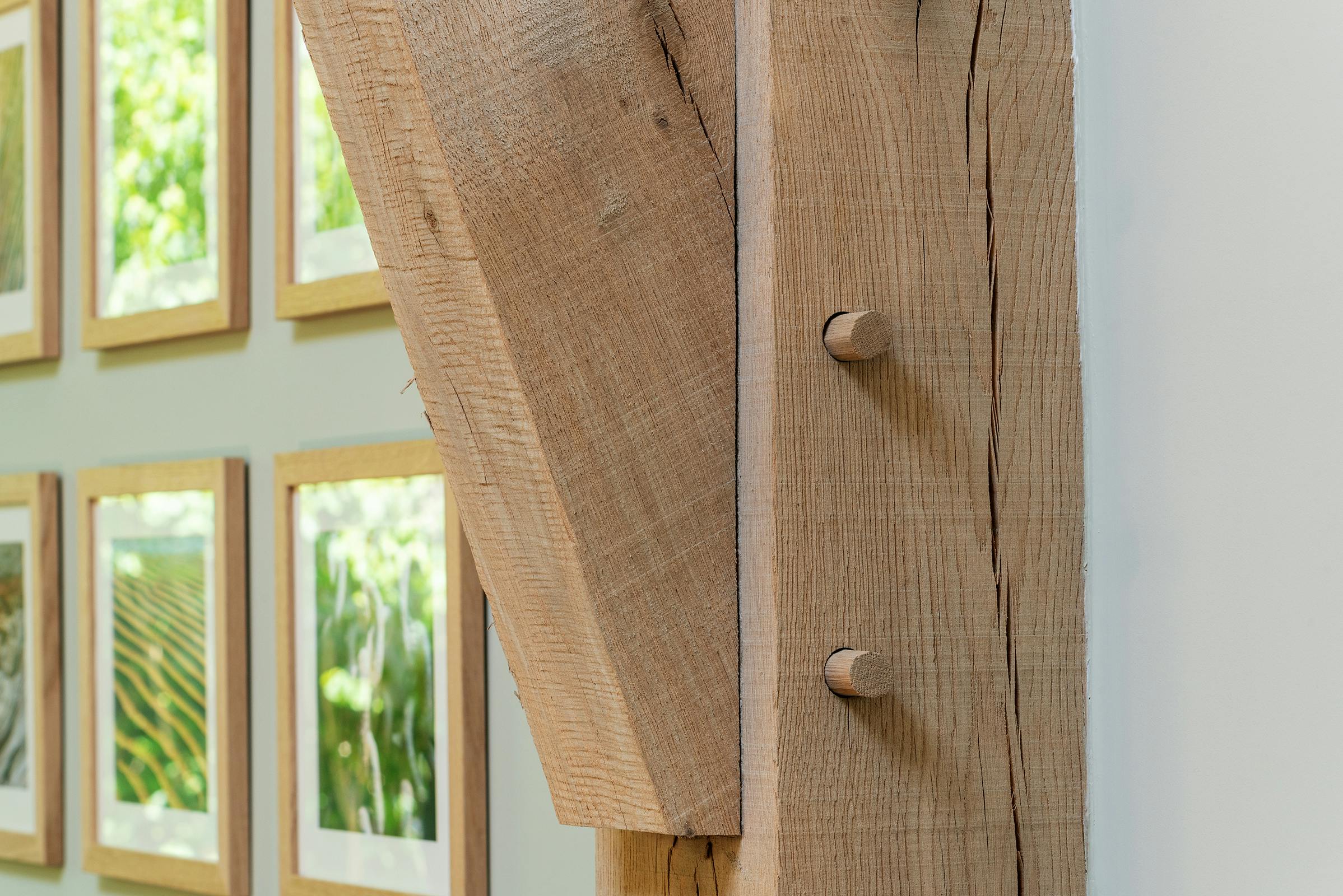 A close up image of an oak post on a structural oak frame in a converted barn