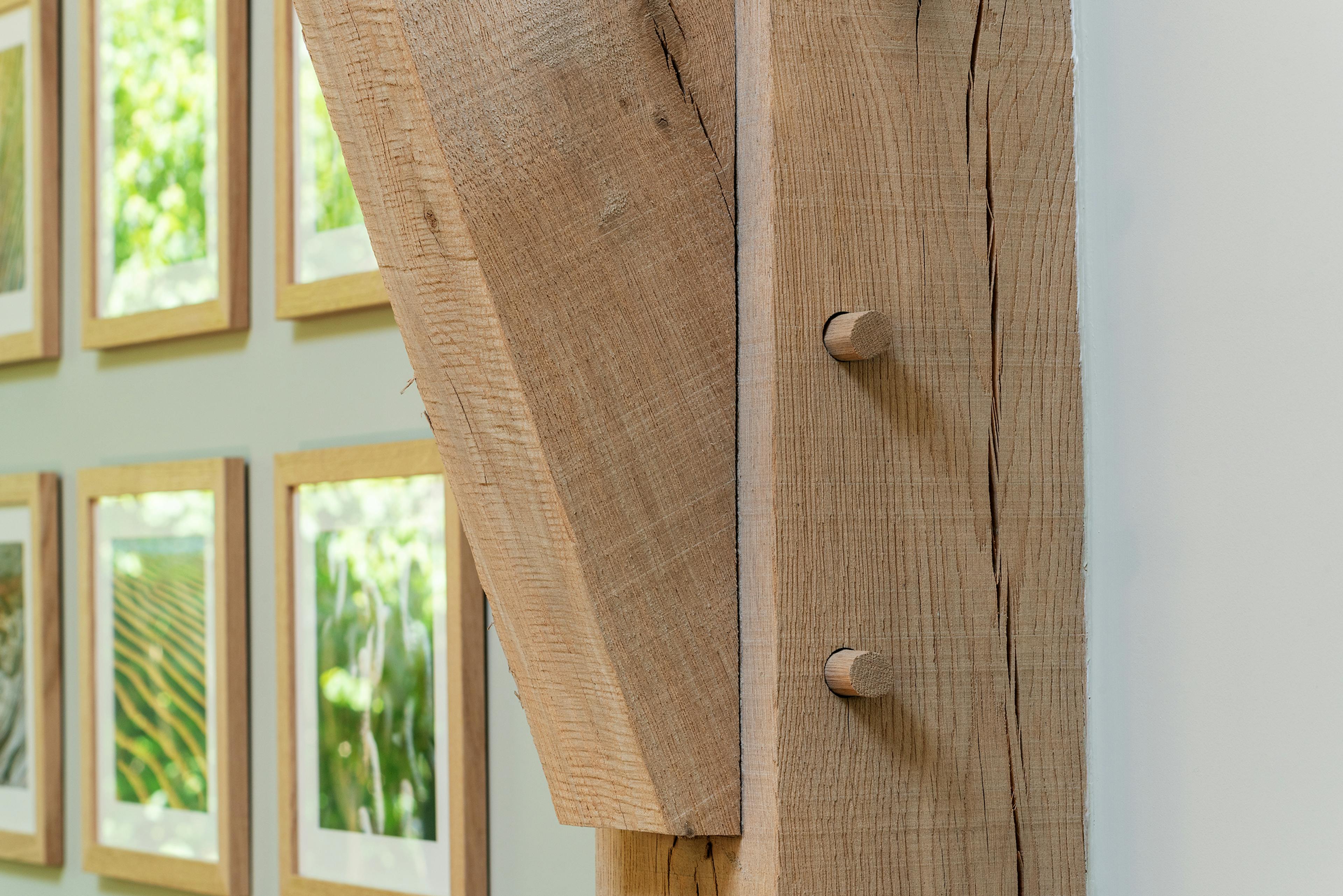 A close up image of an oak post on a structural oak frame in a converted barn