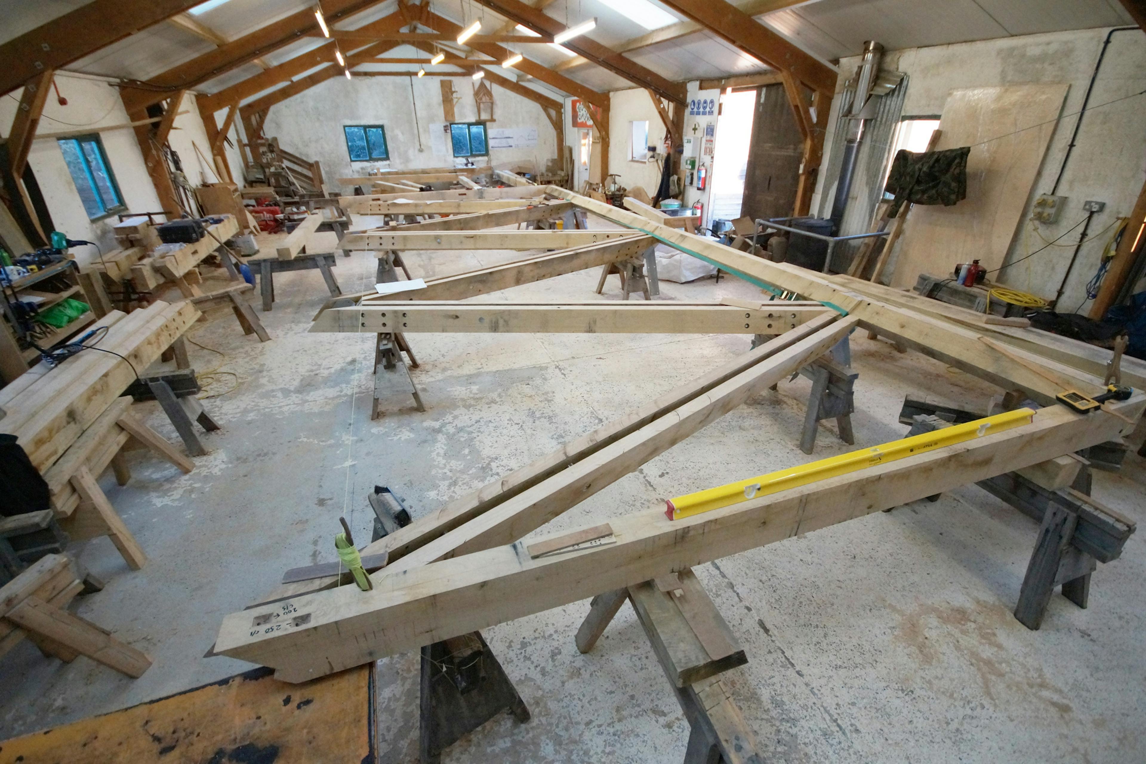 An oak frame with steel connections in a carpenters workshop