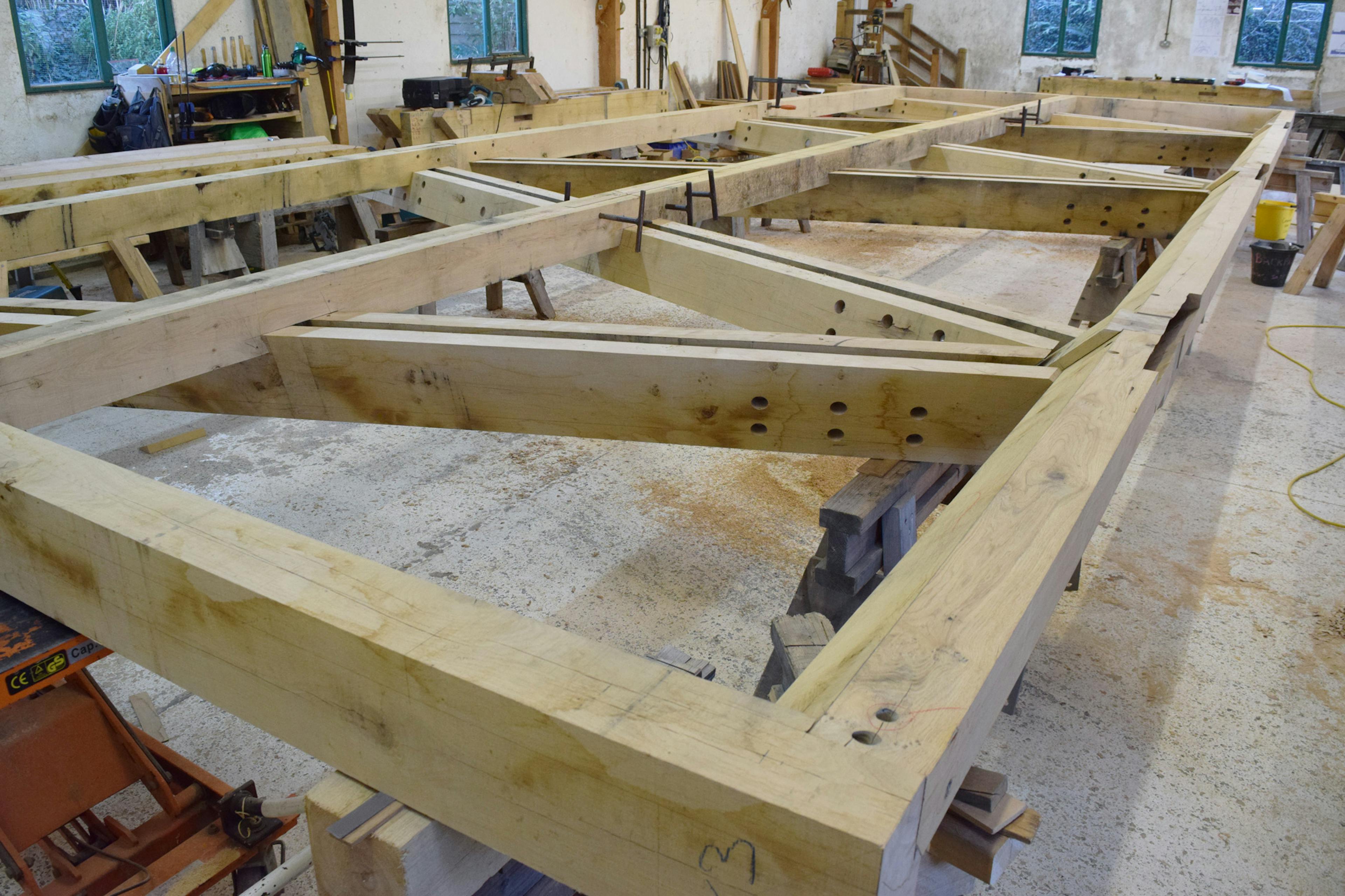 An oak frame with steel connections in a carpenters workshop