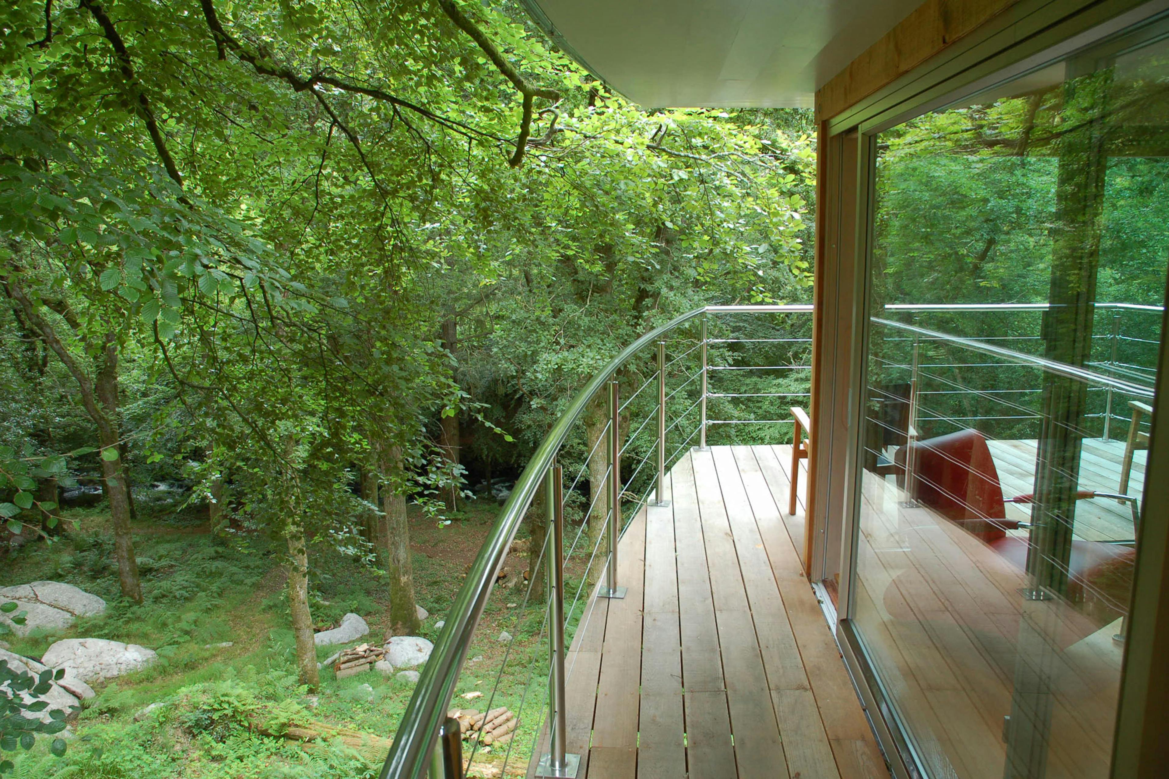 A Douglas fir framed cabin with a wooden balcony around it