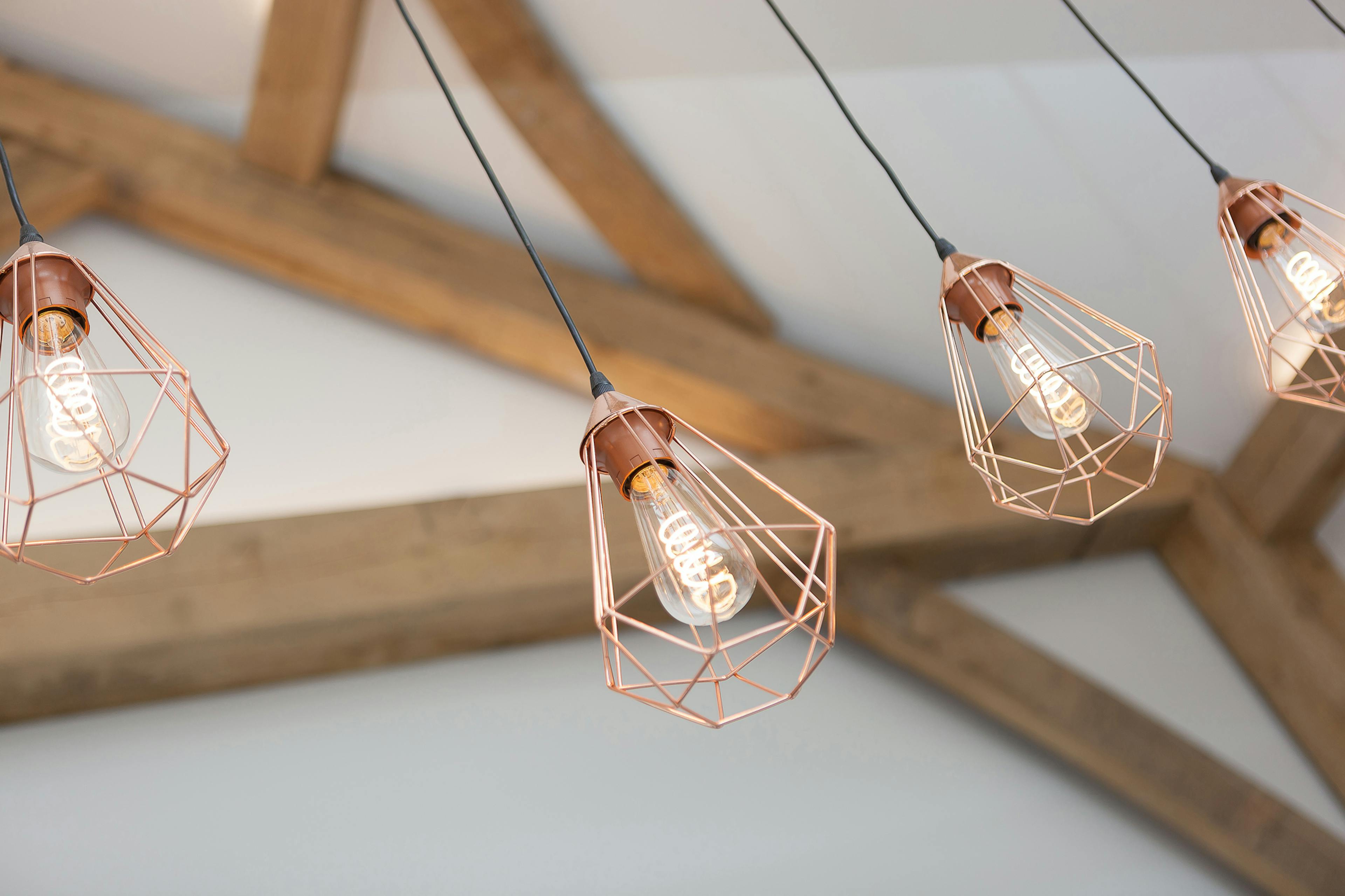 Modern light pendants in front of an oak frame