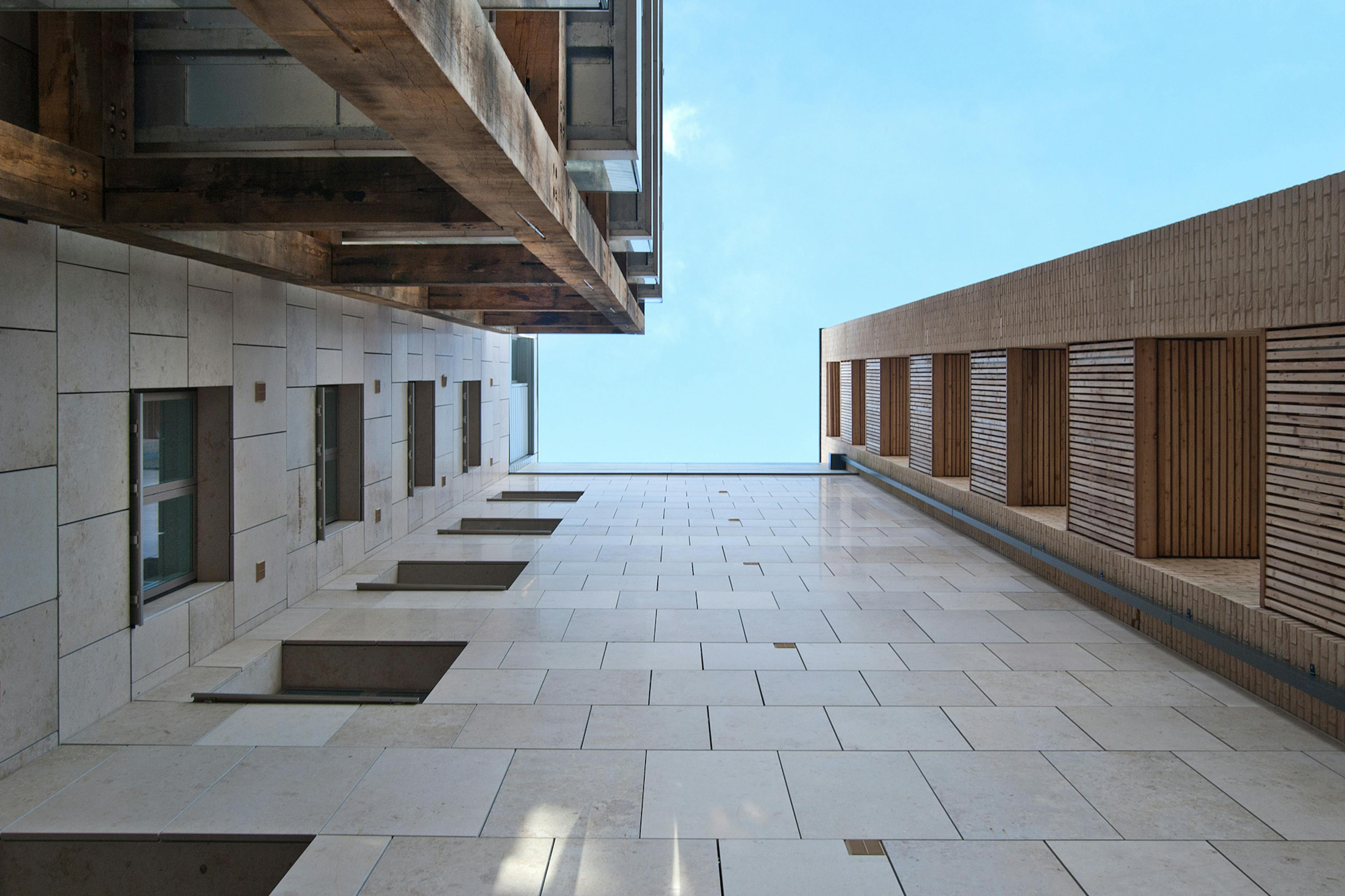Looking up to green oak balconies on a high rise building