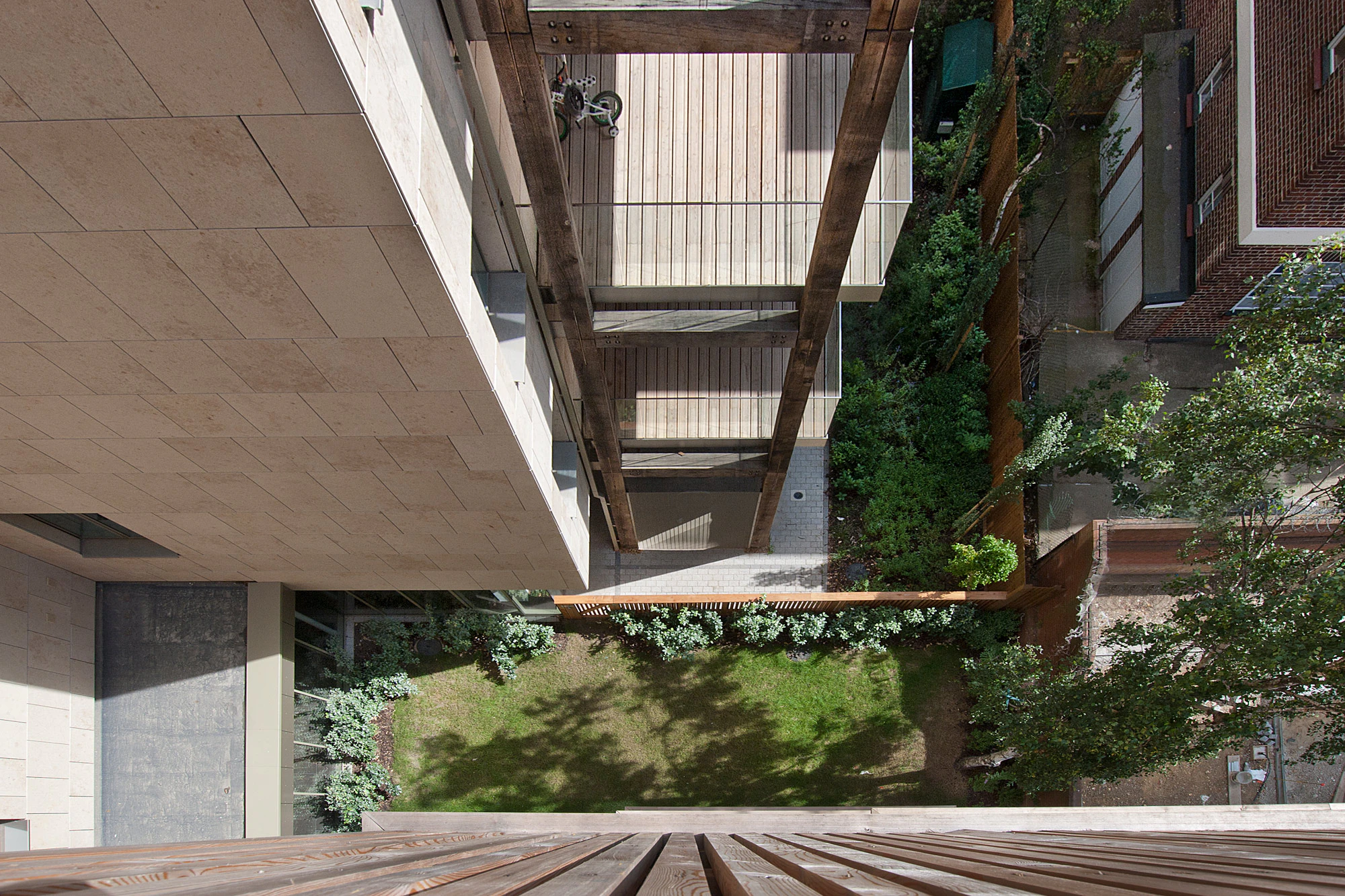 Looking from above onto green oak balconies on a high rise building