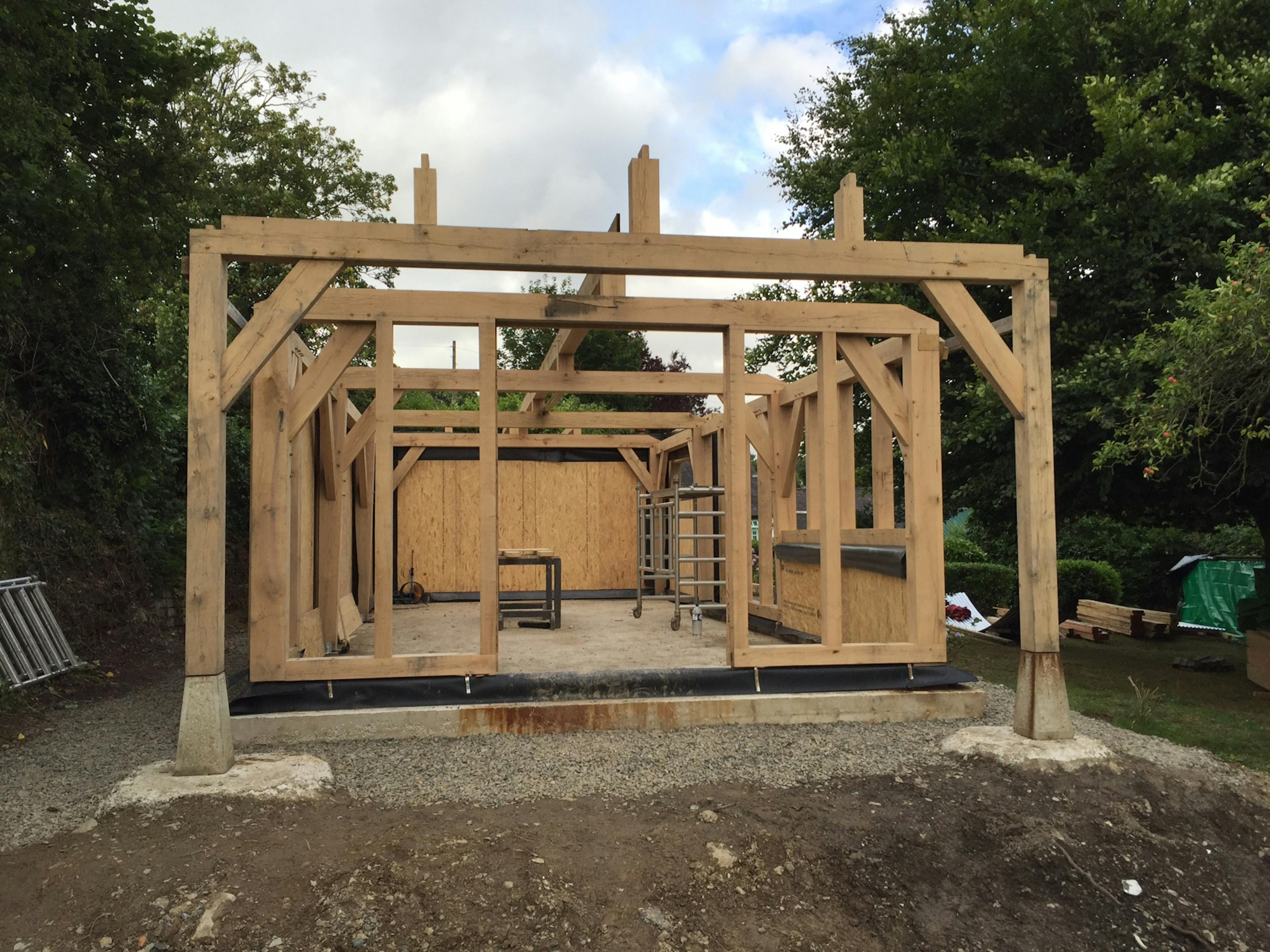An oak framed cabin being installed