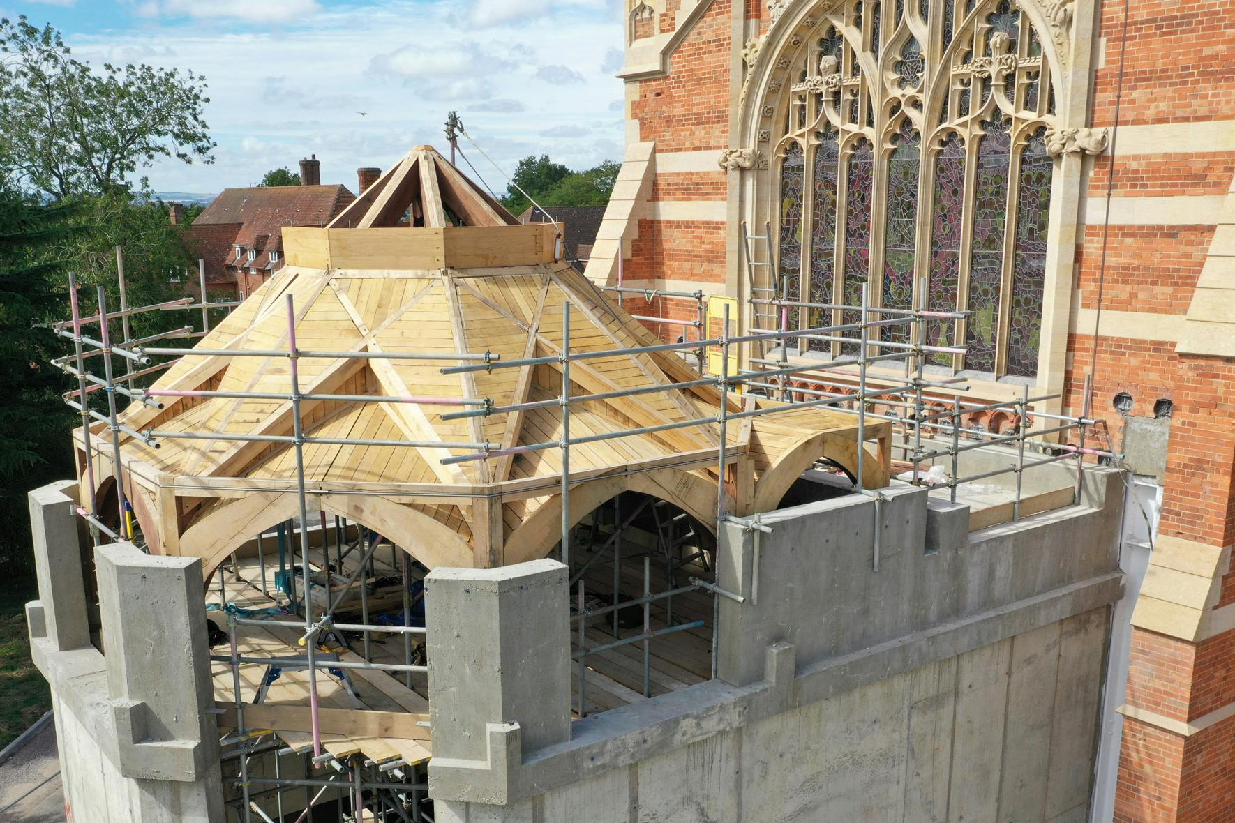 An extension to a 19th century chapel with an octagonal oak framed roof structure during construction